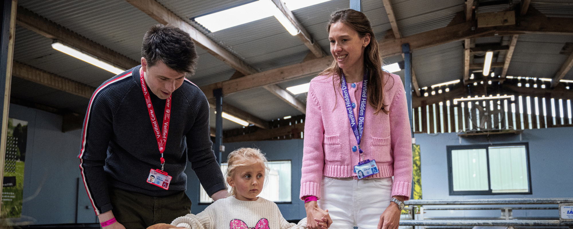 Man with a National Carers Card and woman with a National Disability Card and a child at a farm park