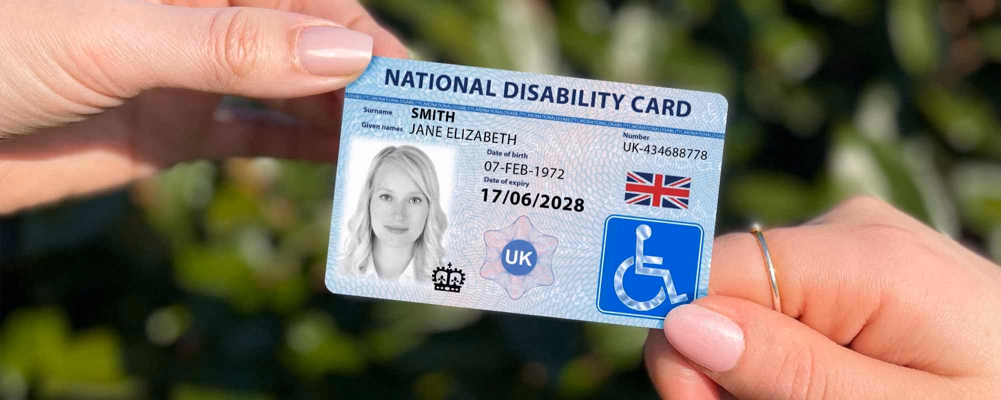 Two hands holding the National Disability Card