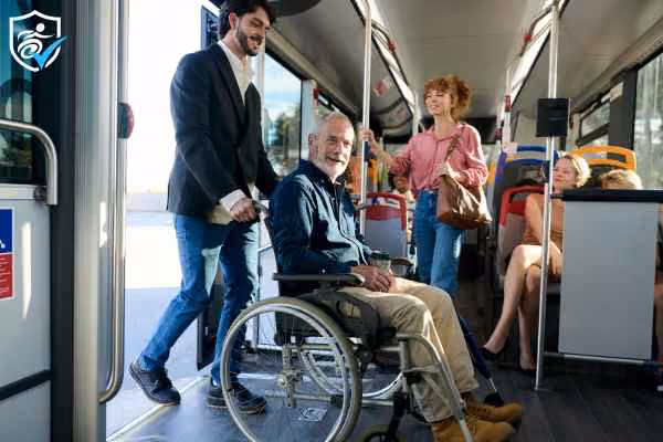 A young man and an older man in a wheelchair who have just boarded a bus