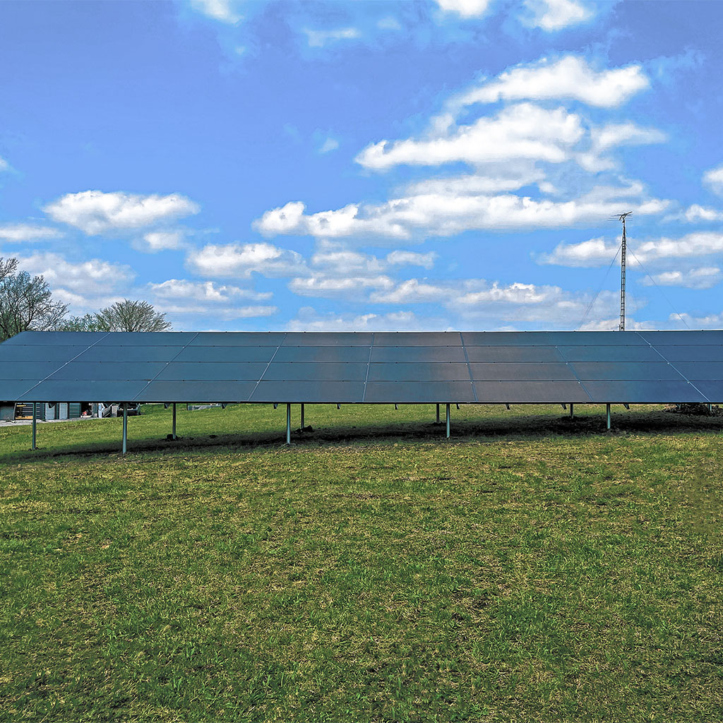Ground-mounted solar panel system installed by Shinnova on a sunny day