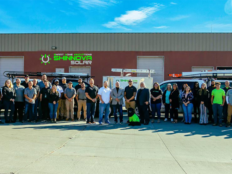 Shinnova team standing in front of company facility