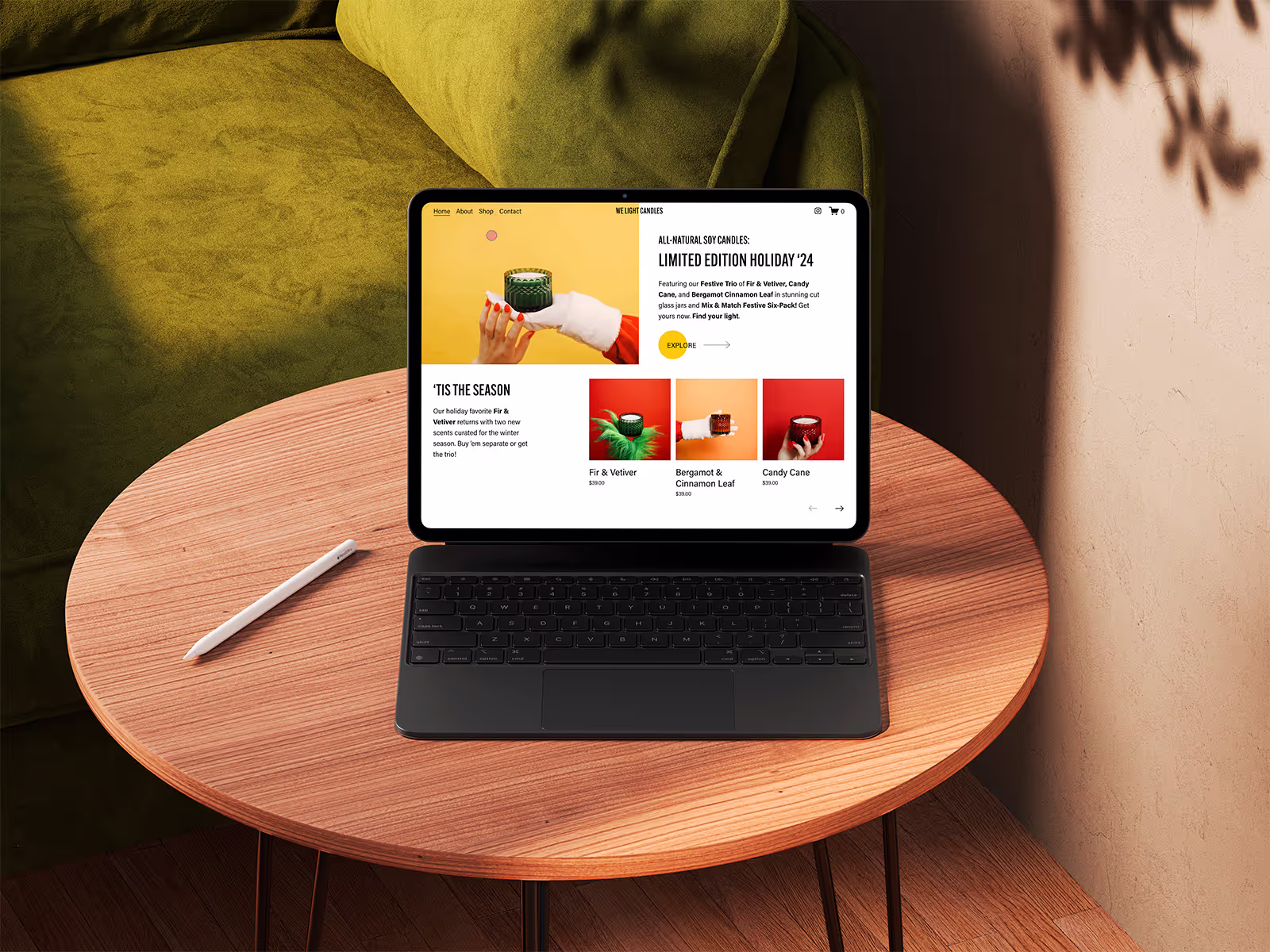 We Light's website shown fullscreen on a tablet, featuring their holiday candle collection.