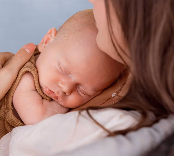 Woman holds her baby
