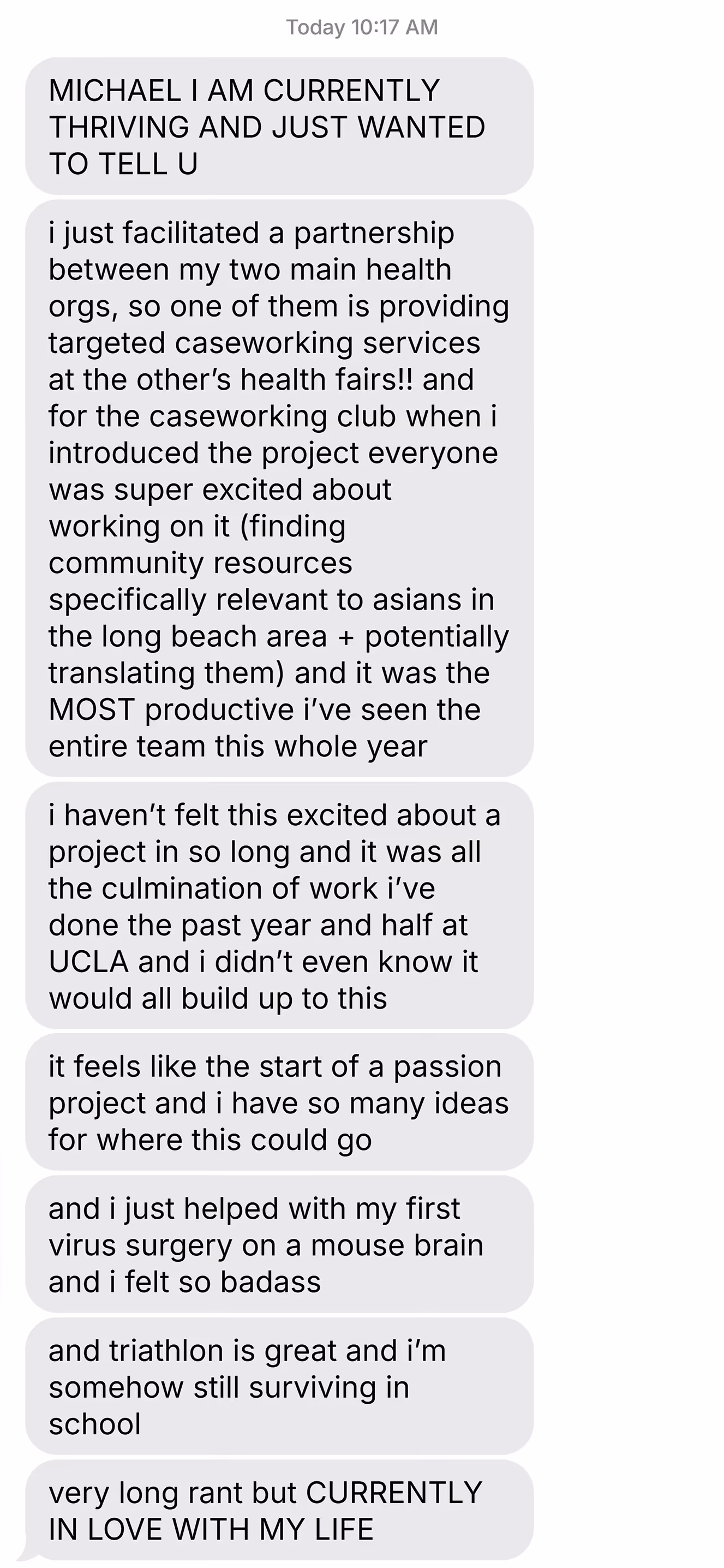 Screenshot of a text message expressing excitement about facilitating a health partnership, productive teamwork at UCLA, involvement in virus surgery on a mouse brain, enjoying triathlon, and overall feeling in love with life.
