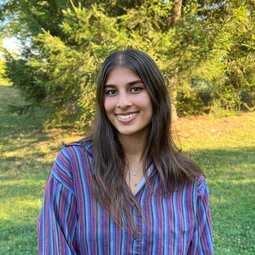 Headshot of woman with brunette hair in outdoor location