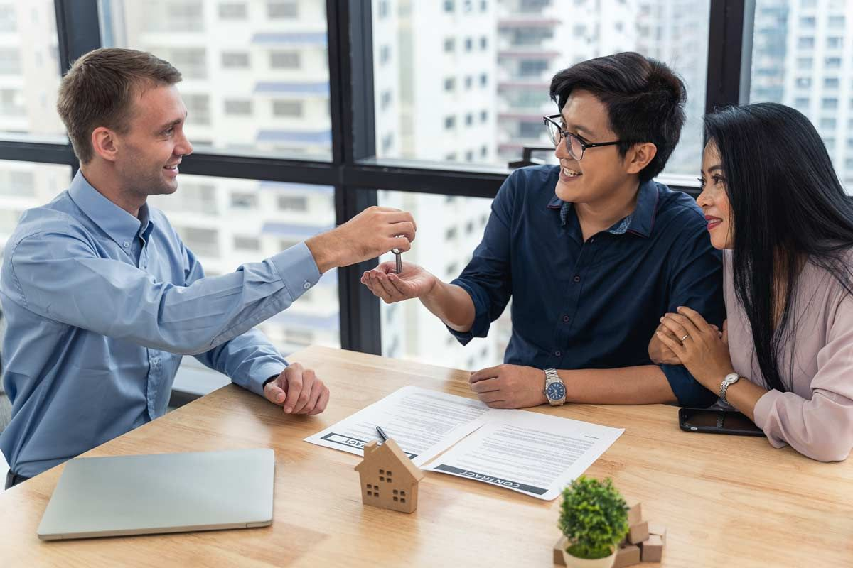 Person handing a couple a key