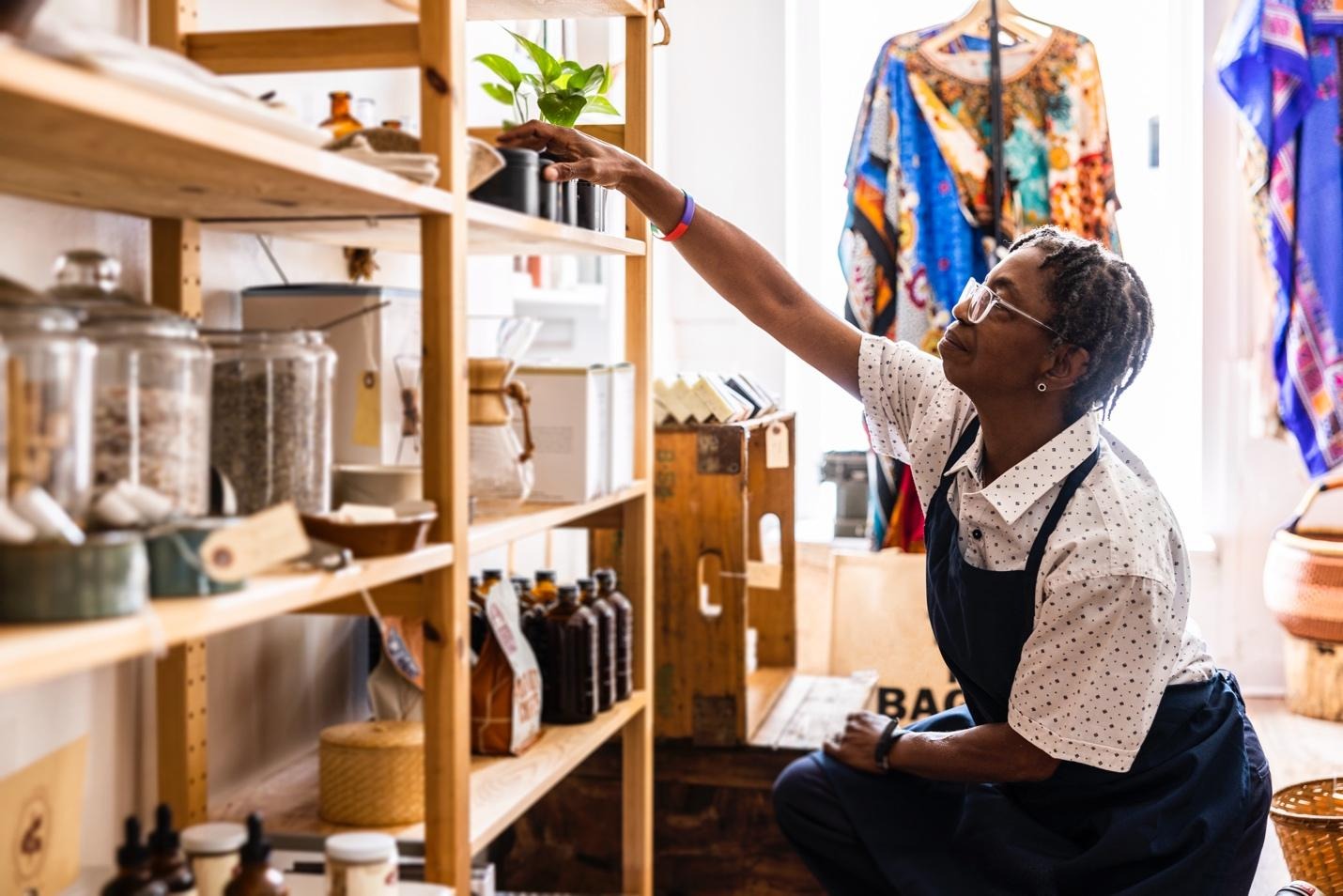 Person sitting in front of shelves