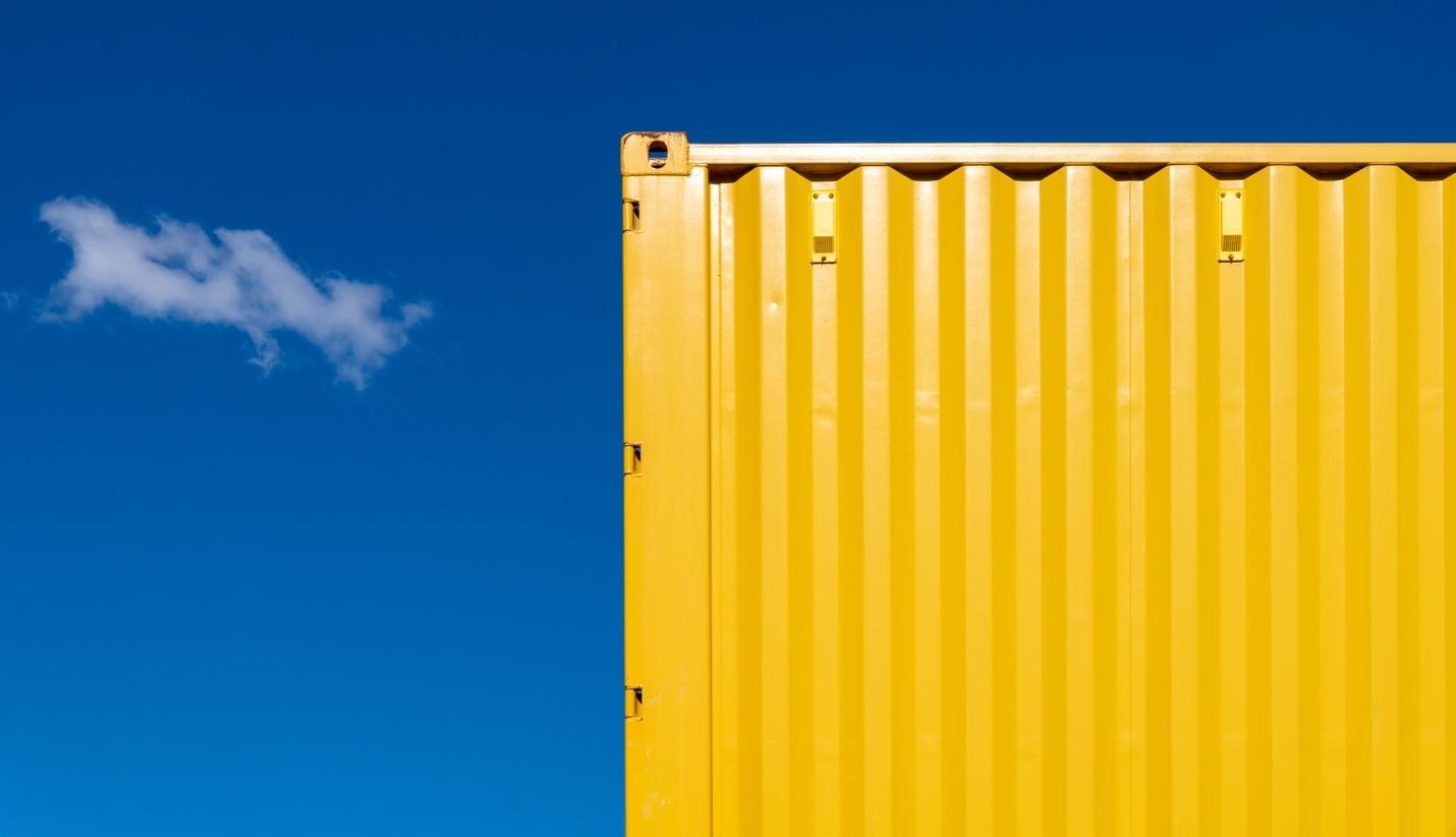 Yellow freight container with the sky as background