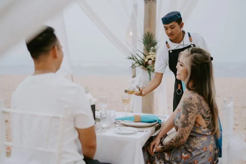 Couple during their proposal dinner in Bali served by a local chef