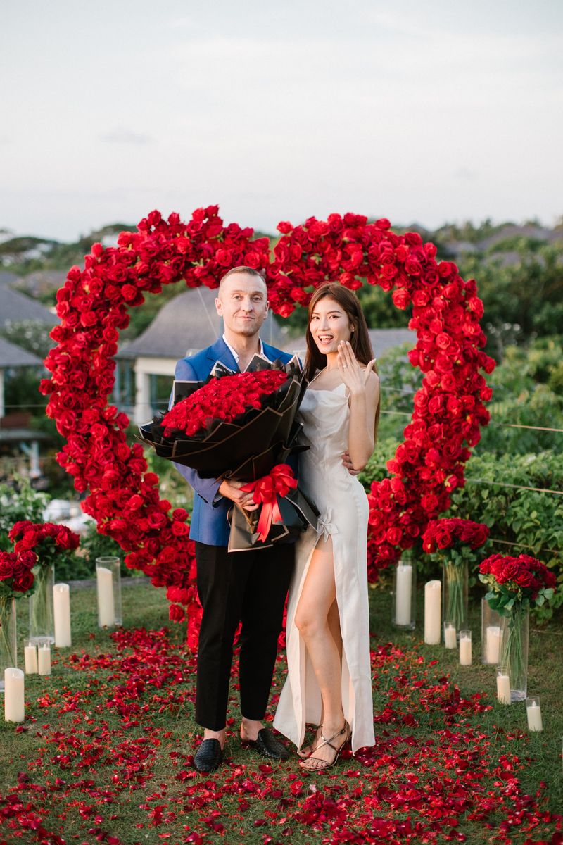 Romantic candlelit proposal dinner with red rose decoration in Bali