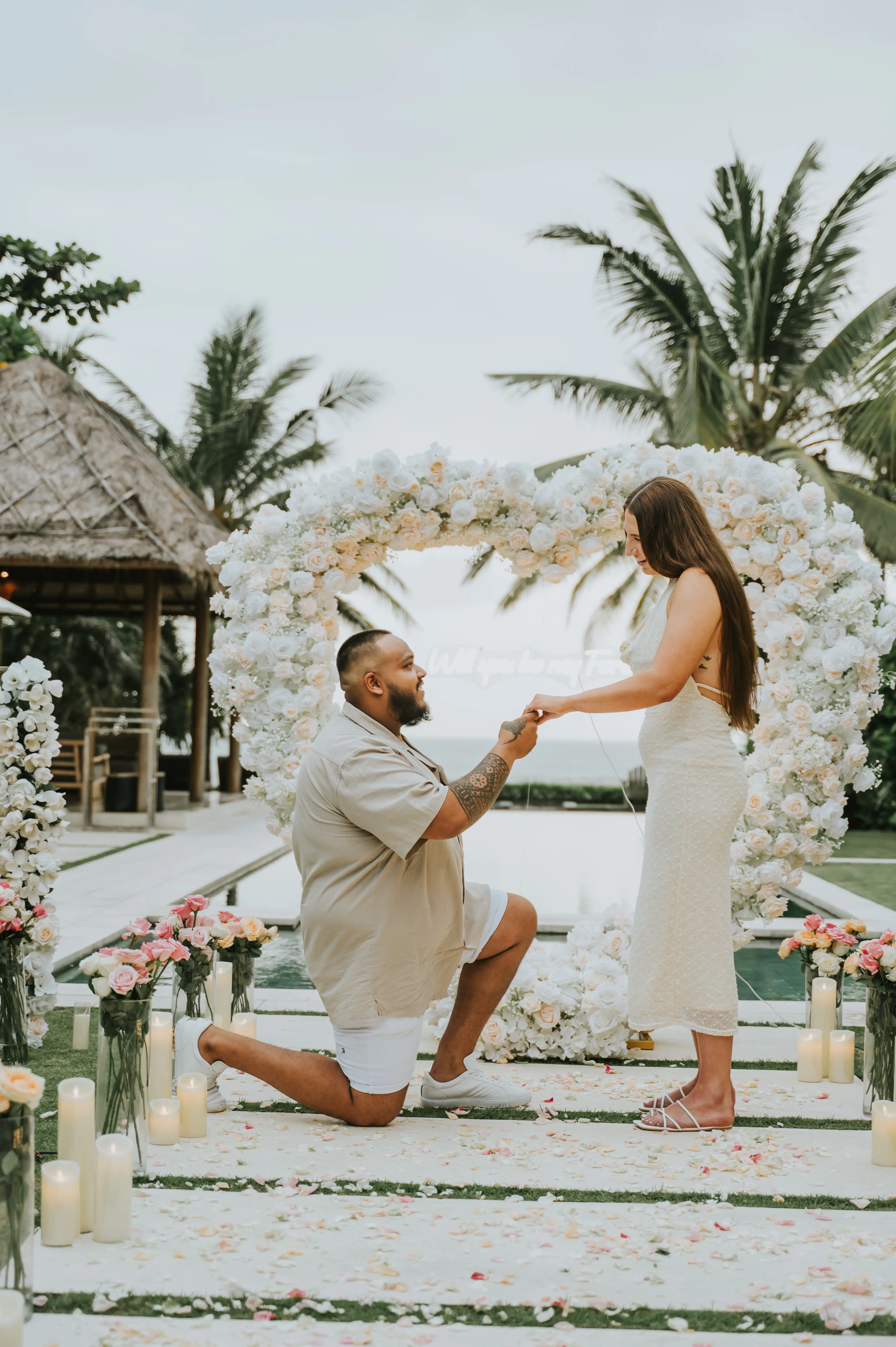 Man lifting fiancée during engagement celebration in Bali