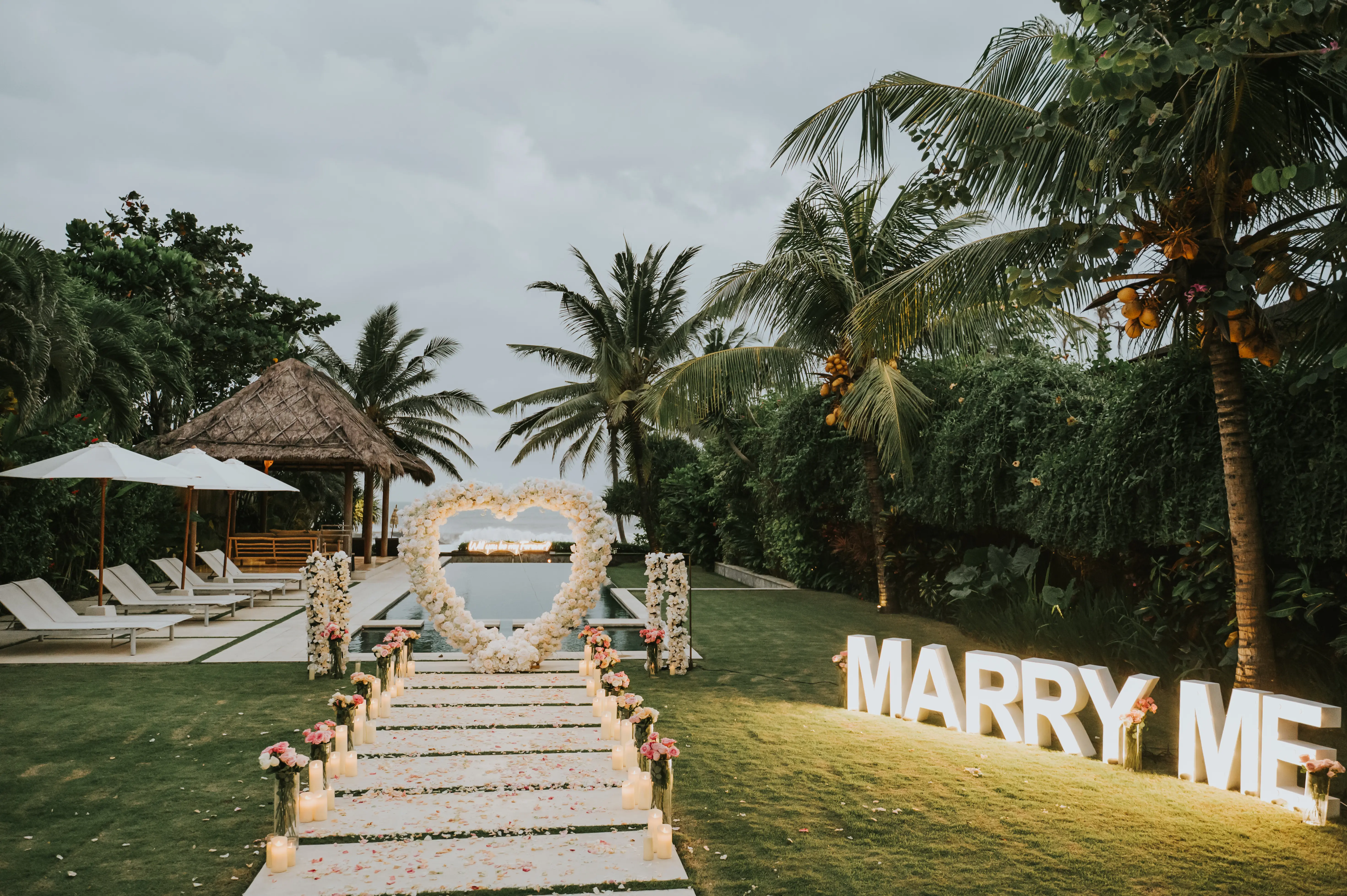 Private Bali villa proposal with “Marry Me” letters and tropical garden backdrop