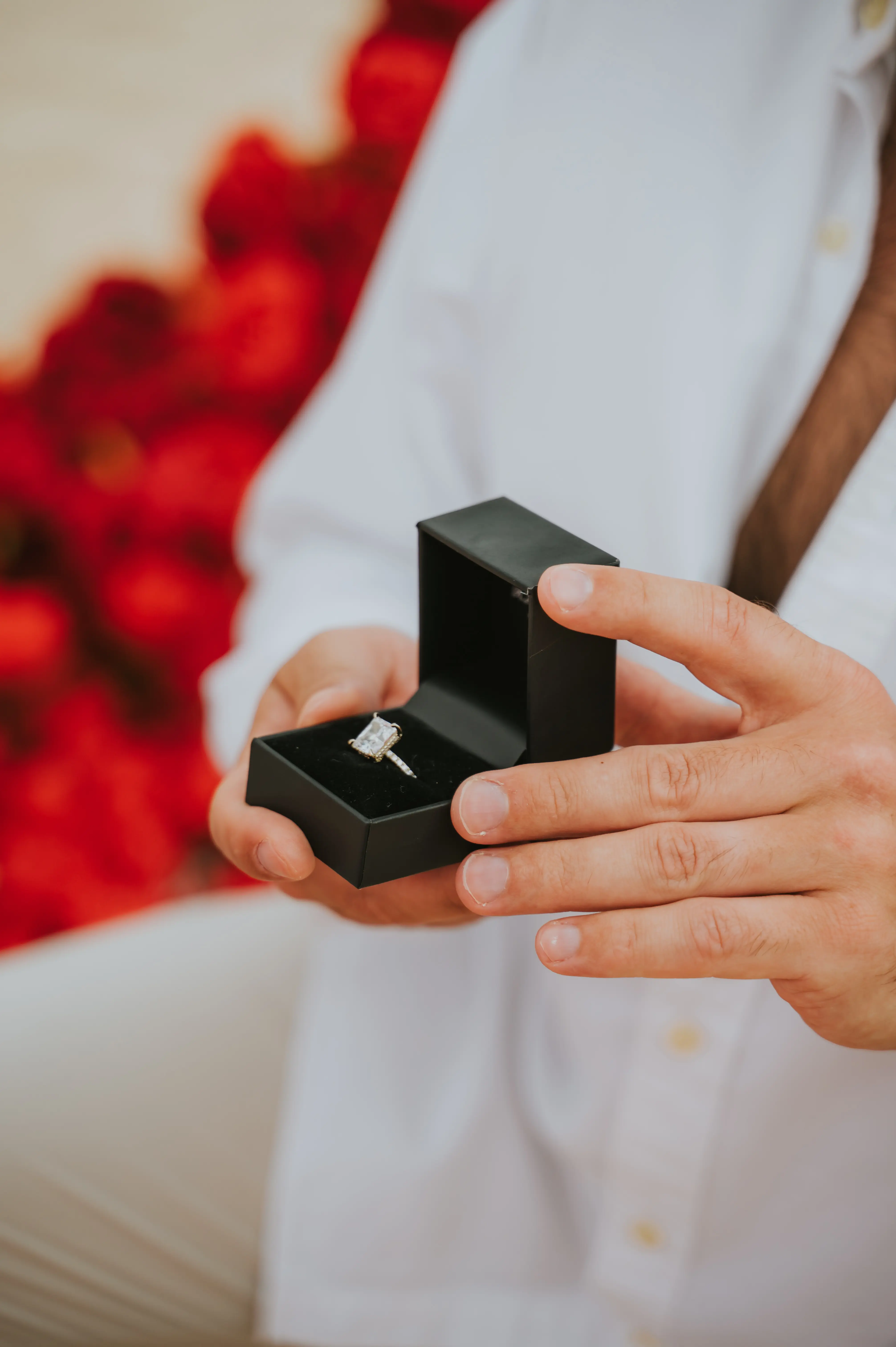 Close-up of man holding engagement ring box during Bali beach proposal