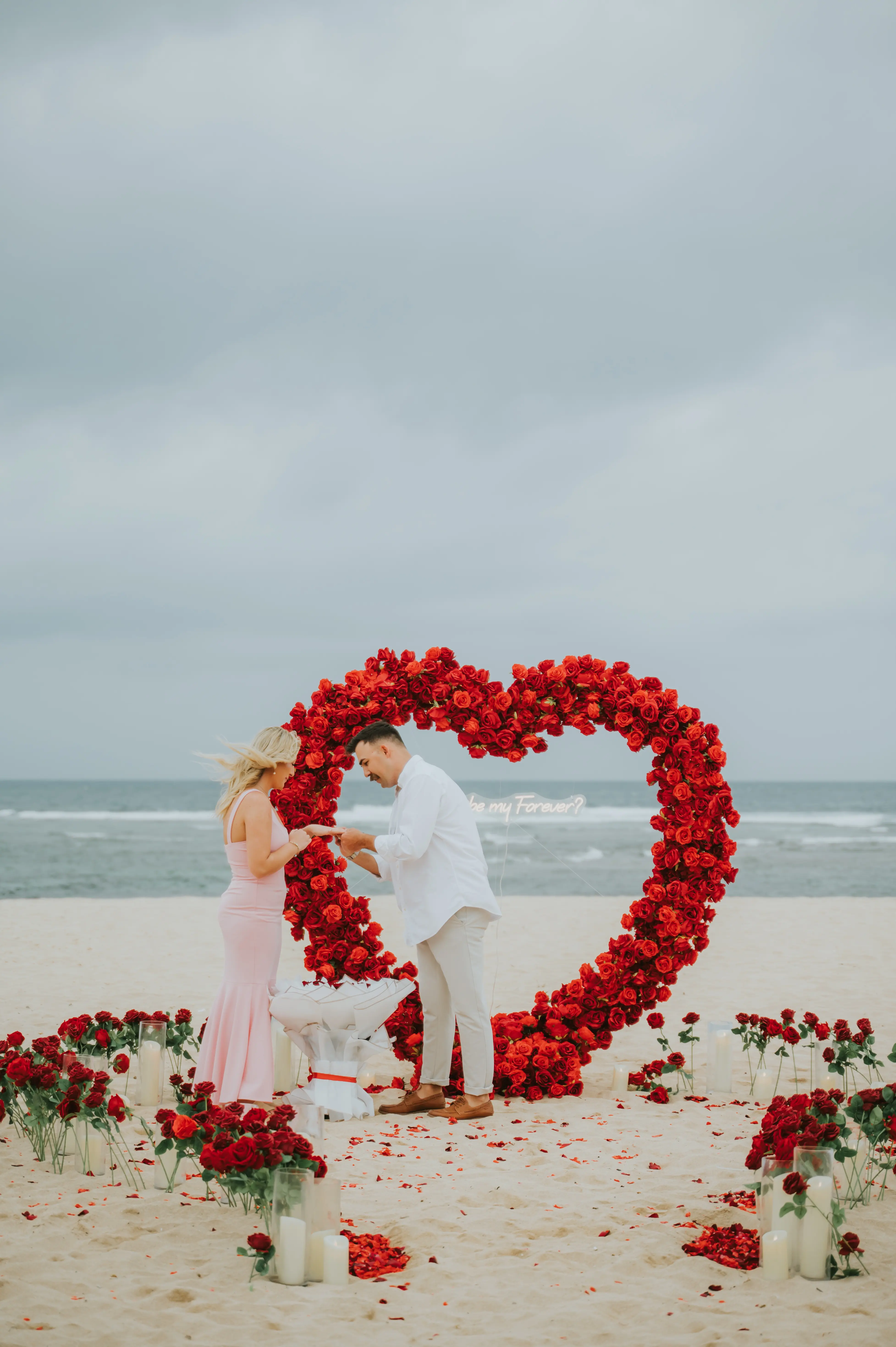 Romantic beach proposal with rose petals in Bali