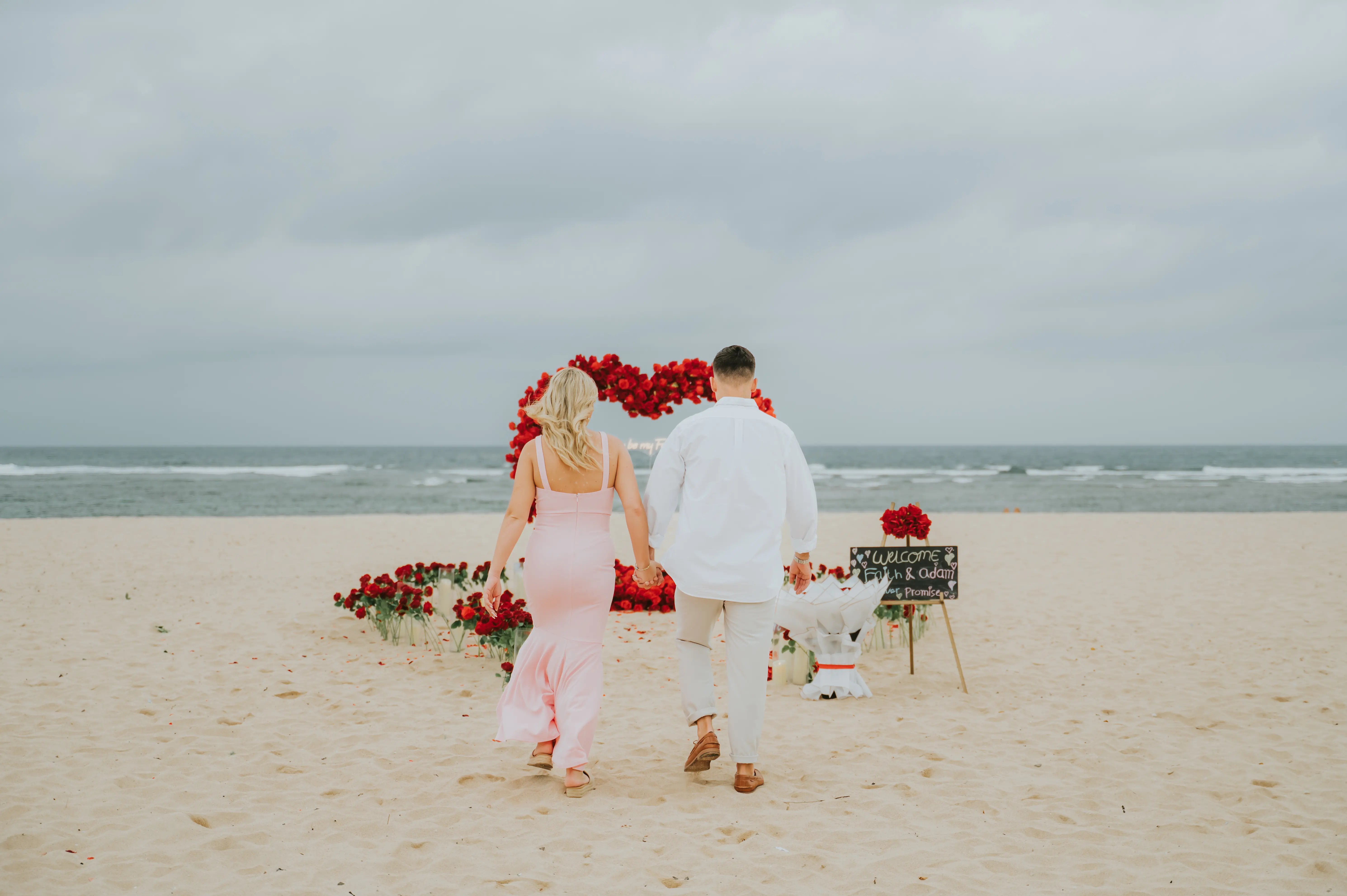 Beach engagement in Bali with romantic red rose heart and floral decor