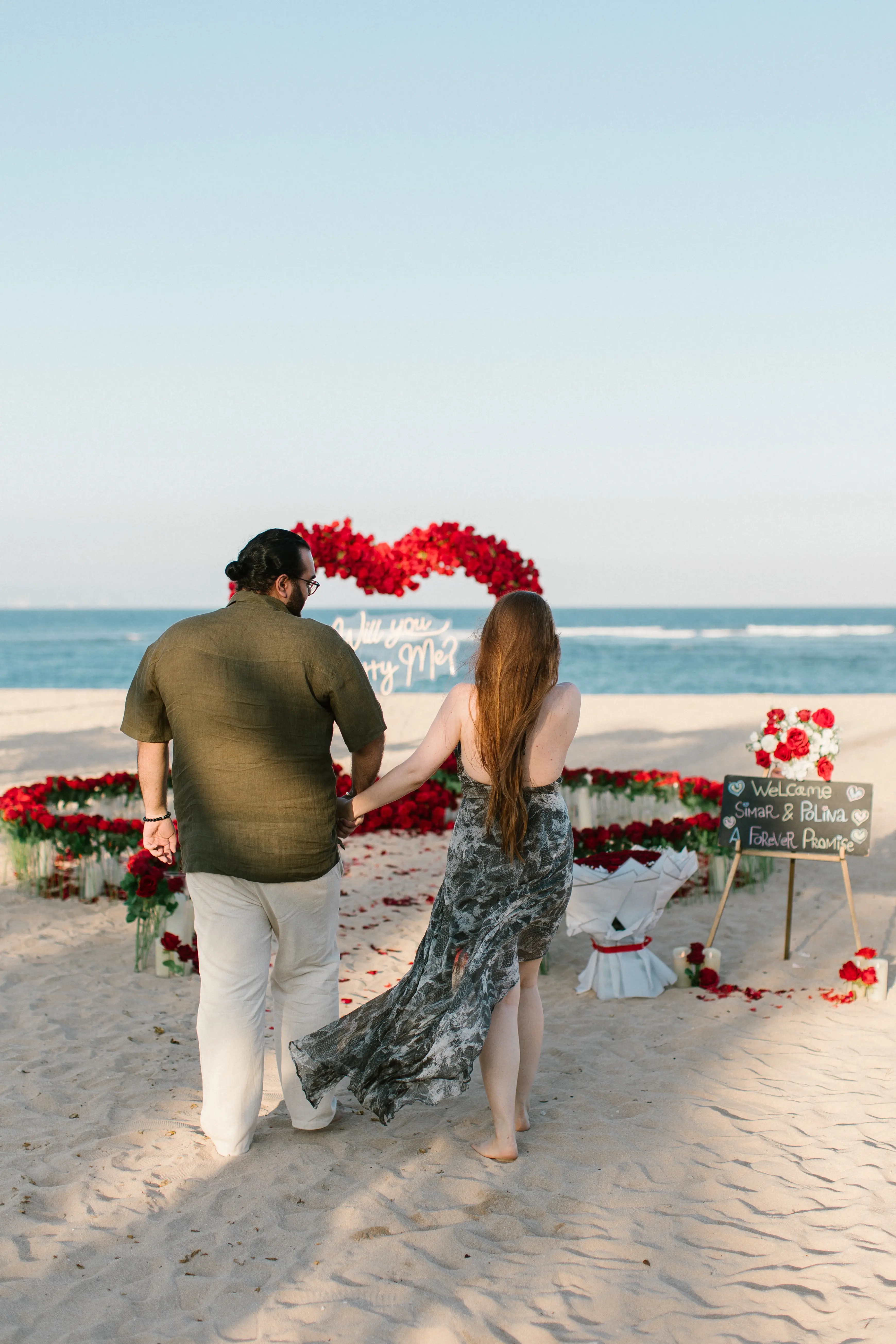 Couple embracing after beach proposal in Bali