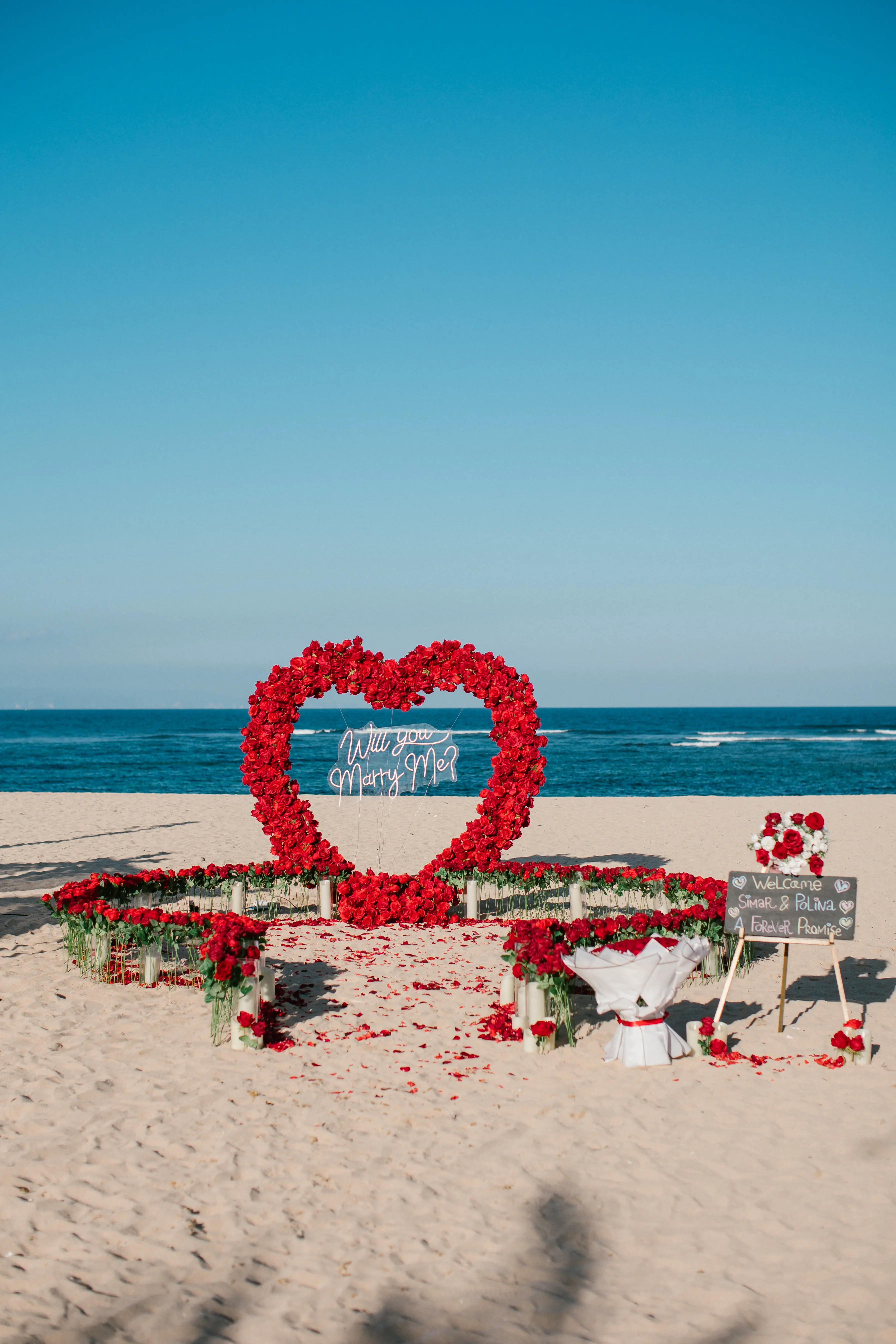Beach proposal setup with red colour theme in bali