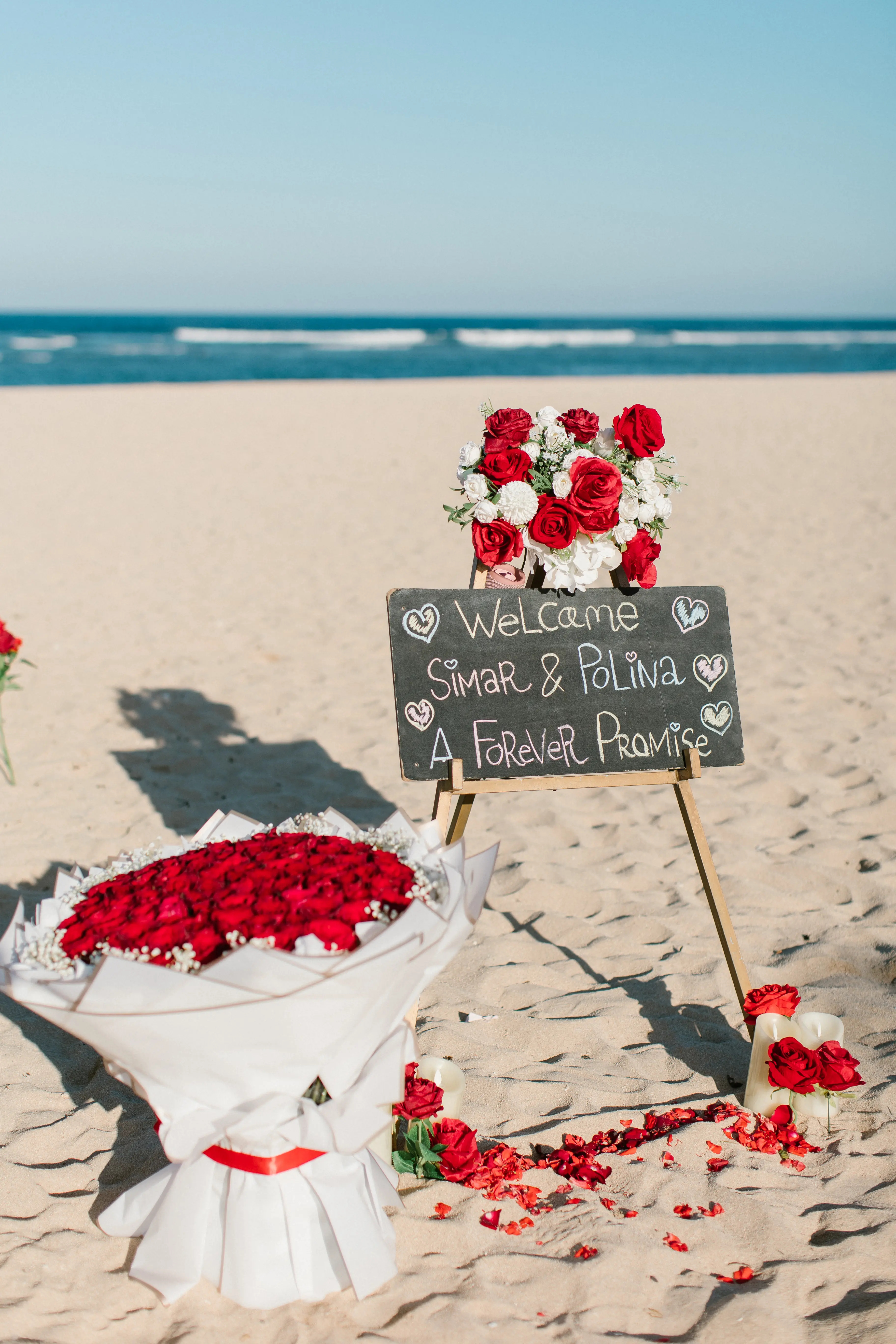 Welcome sign and bouquet for romantic marriage proposal on Bali beach