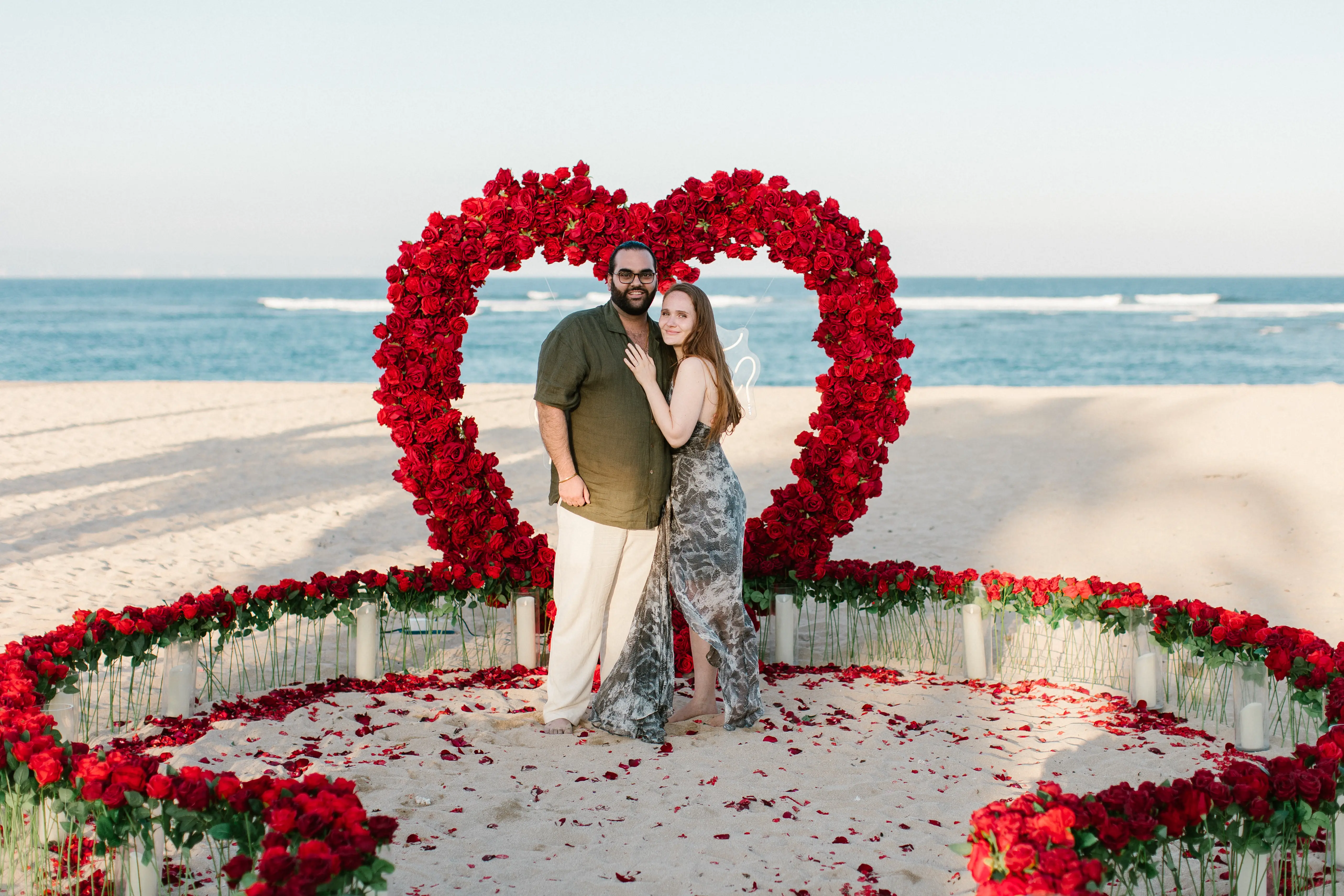 Heart-shaped floral proposal decoration on Bali beach with ocean view