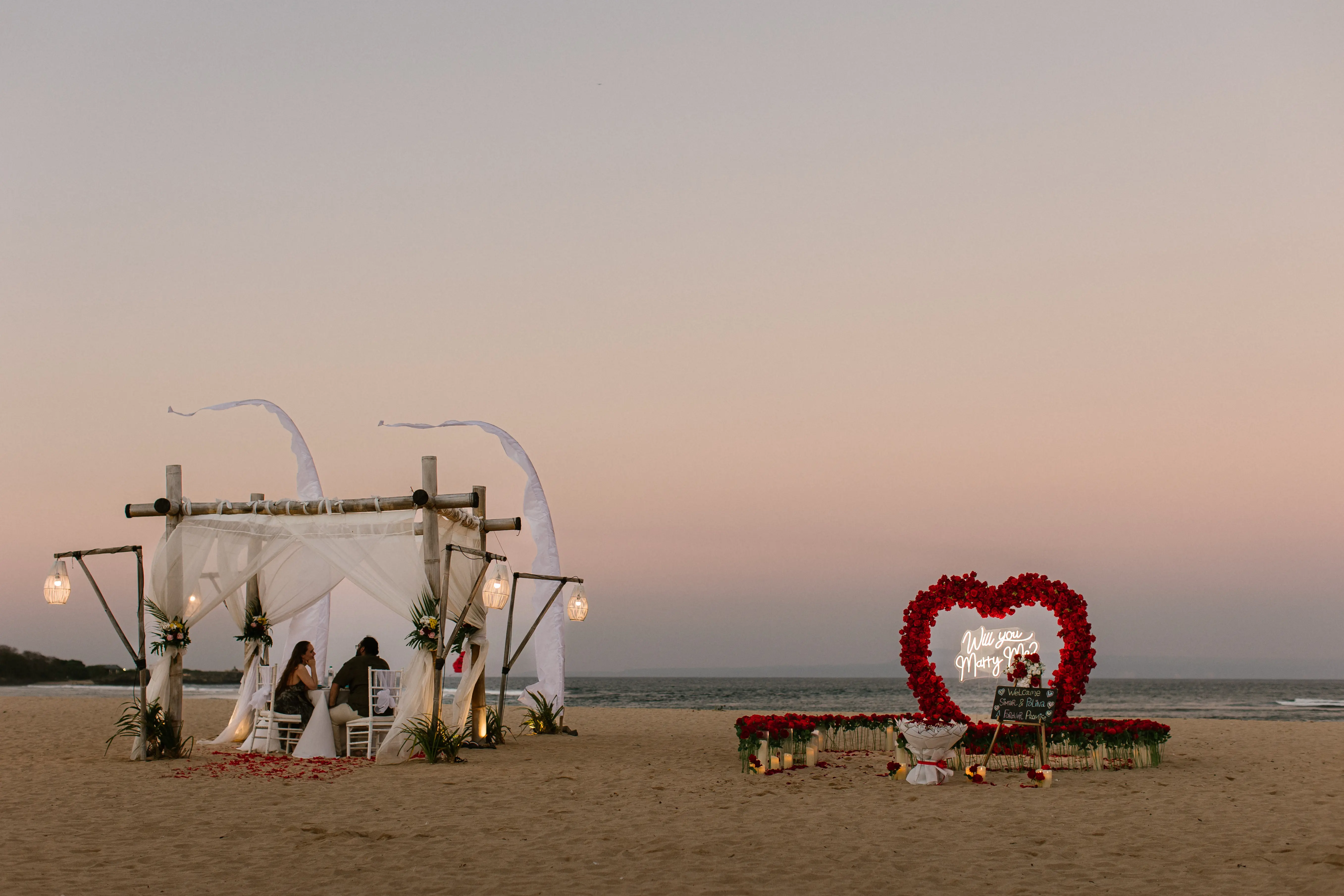 Elegant Bali beach proposal decoration with floral arch and heart arrangement