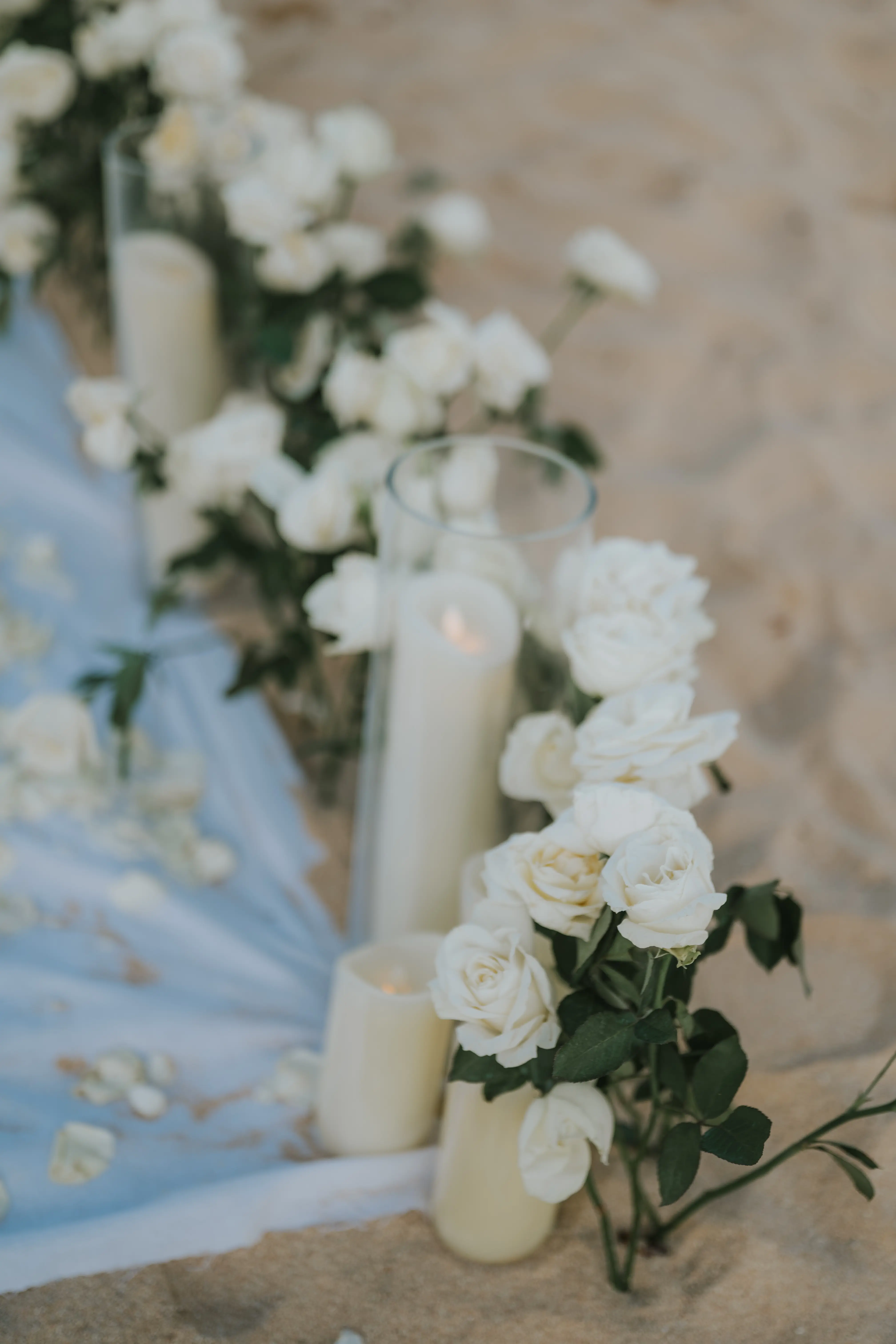 Close-up of elegant white rose aisle arrangement.