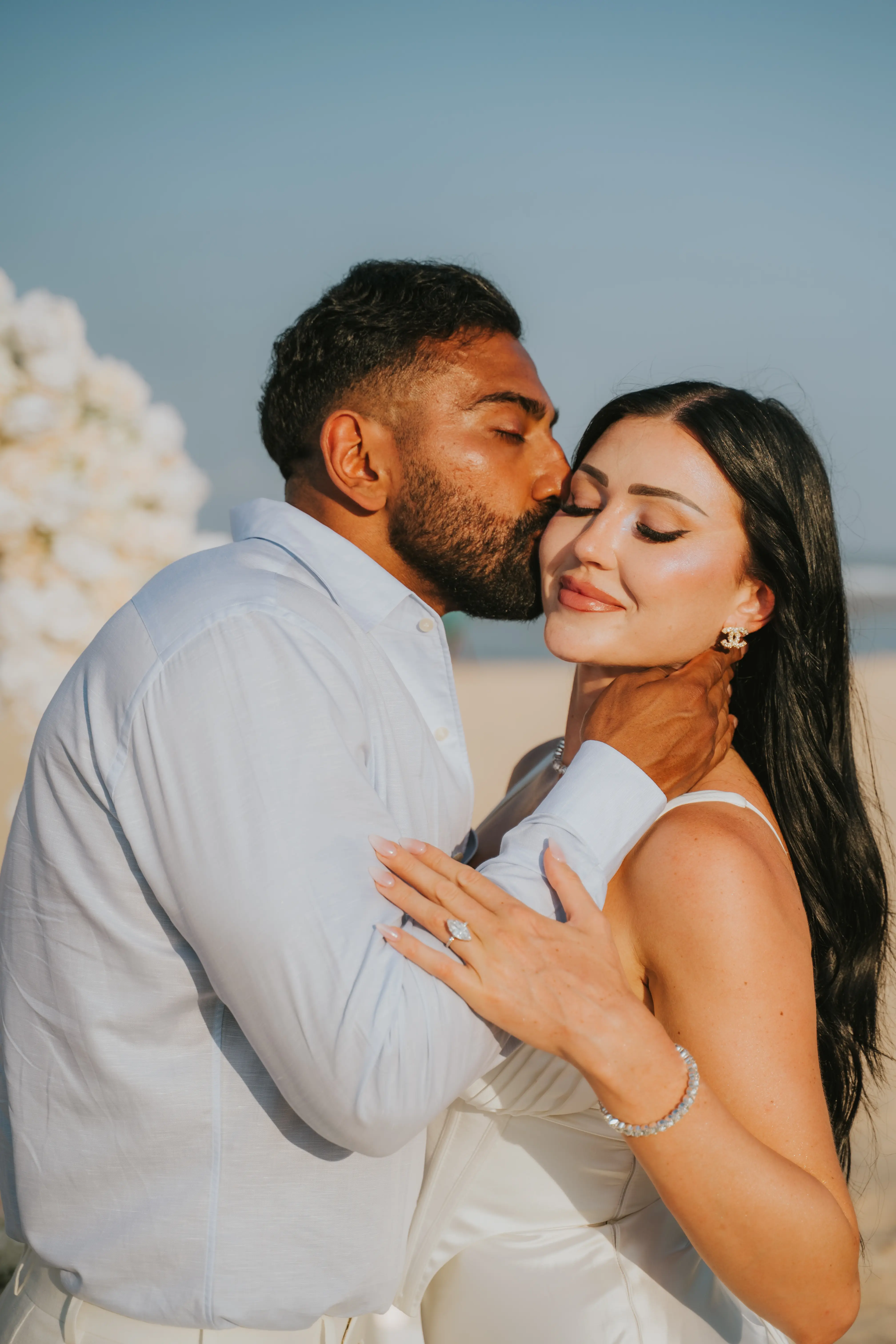 Close-up of happy couple embracing after proposal.