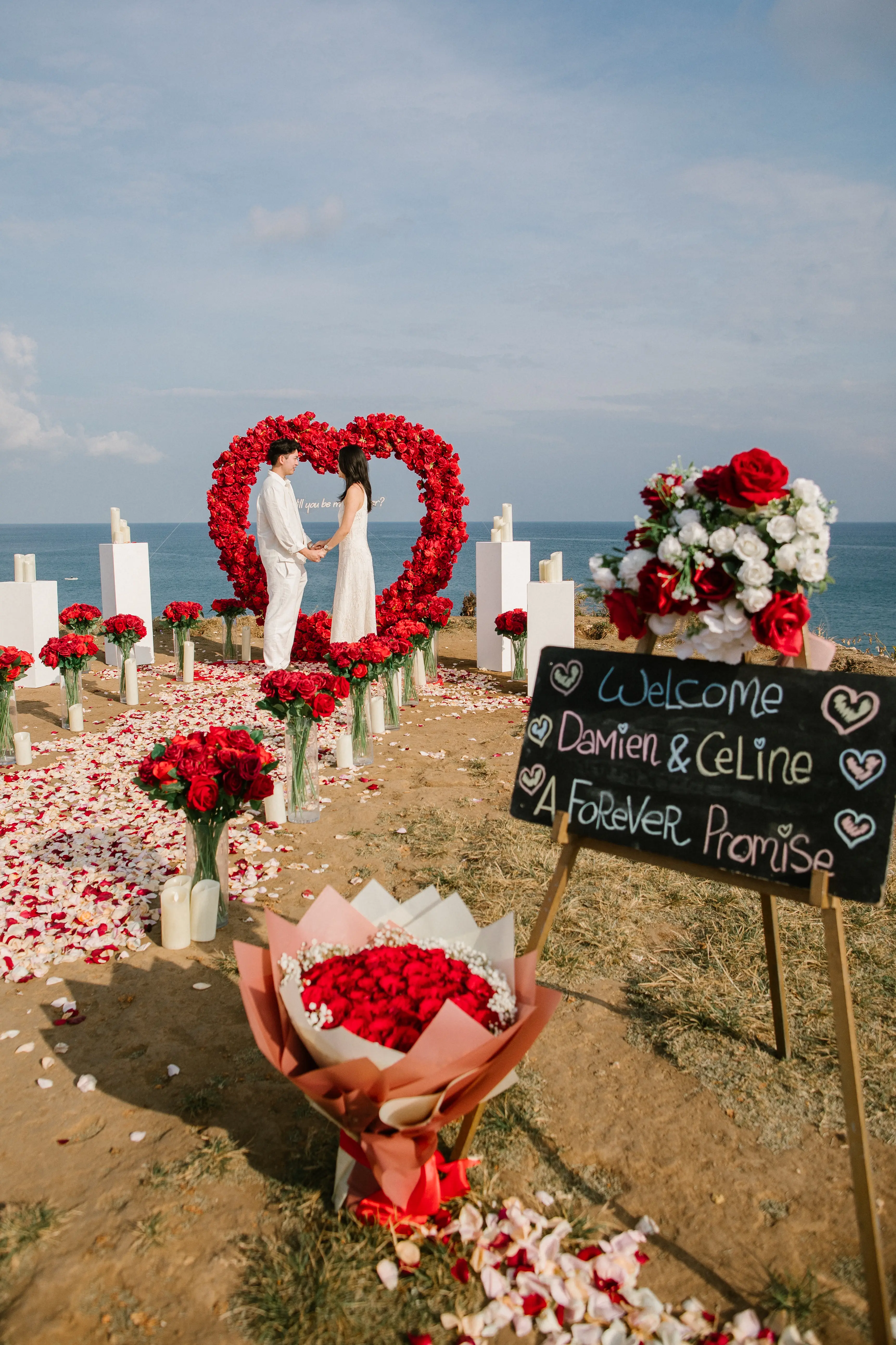 Dream Bali marriage proposal setup with red roses and ocean backdrop
