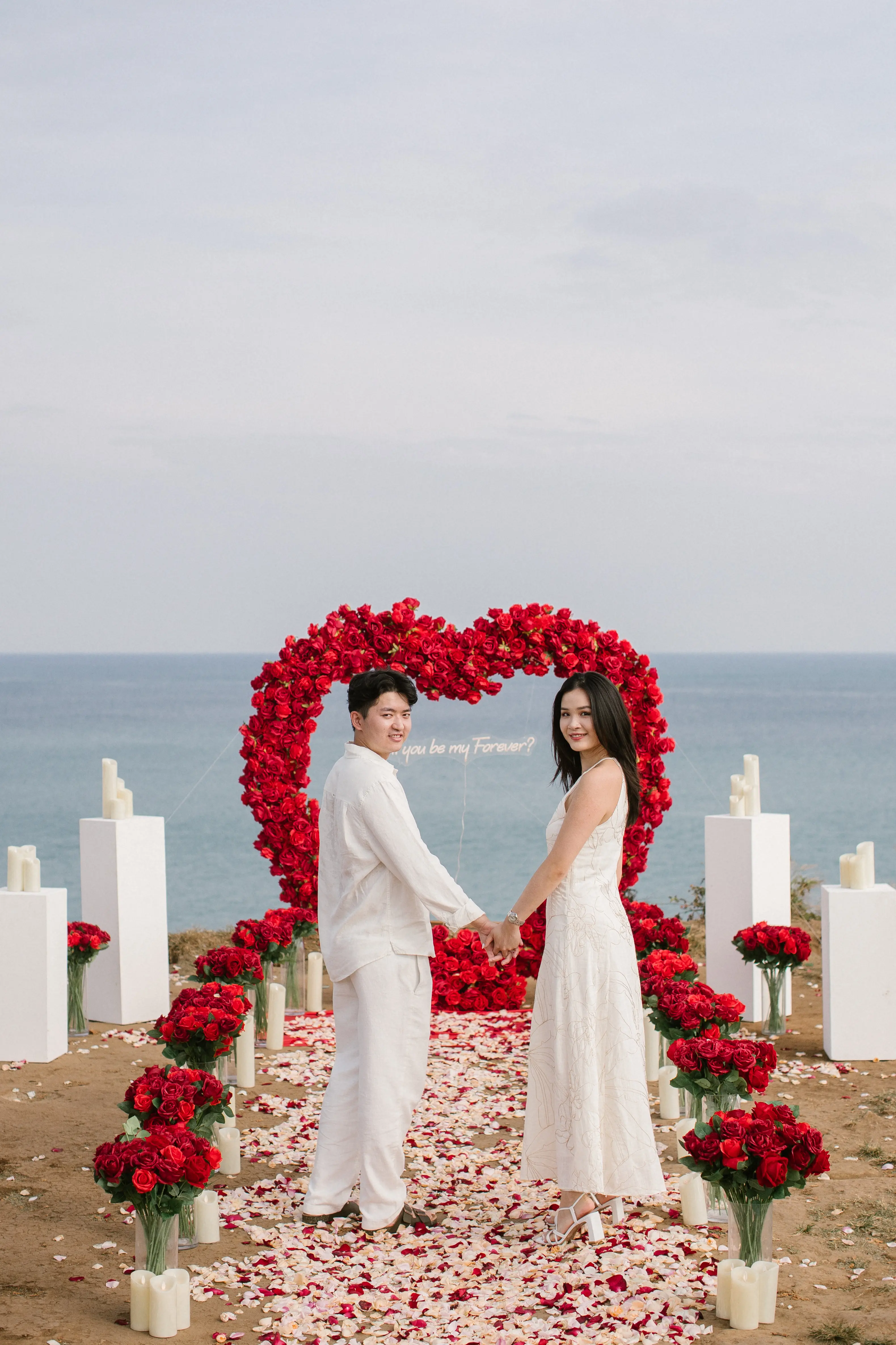 Surprise marriage proposal on Bali cliff with ocean panorama