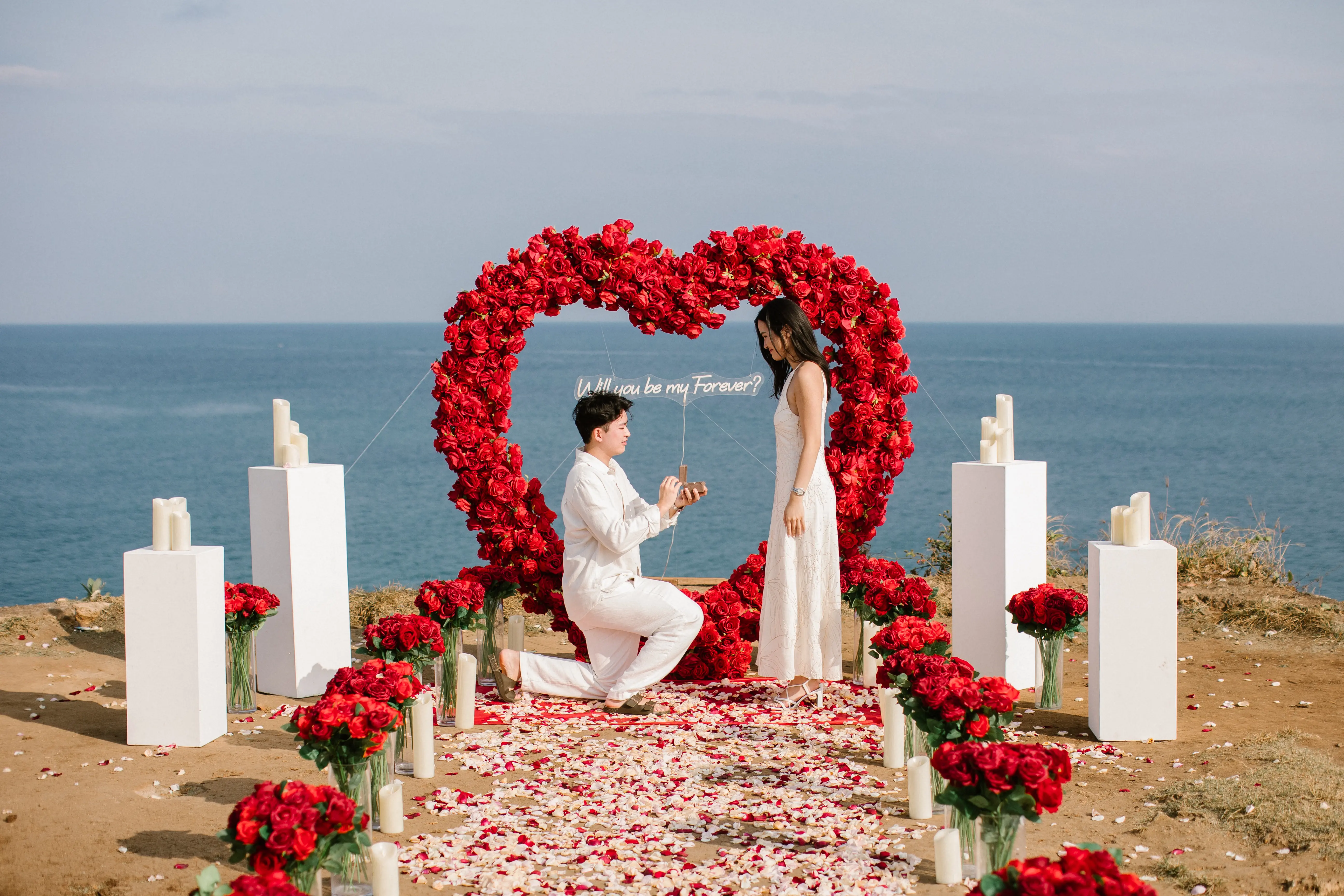 Marriage proposal on Bali cliff overlooking the Indian Ocean