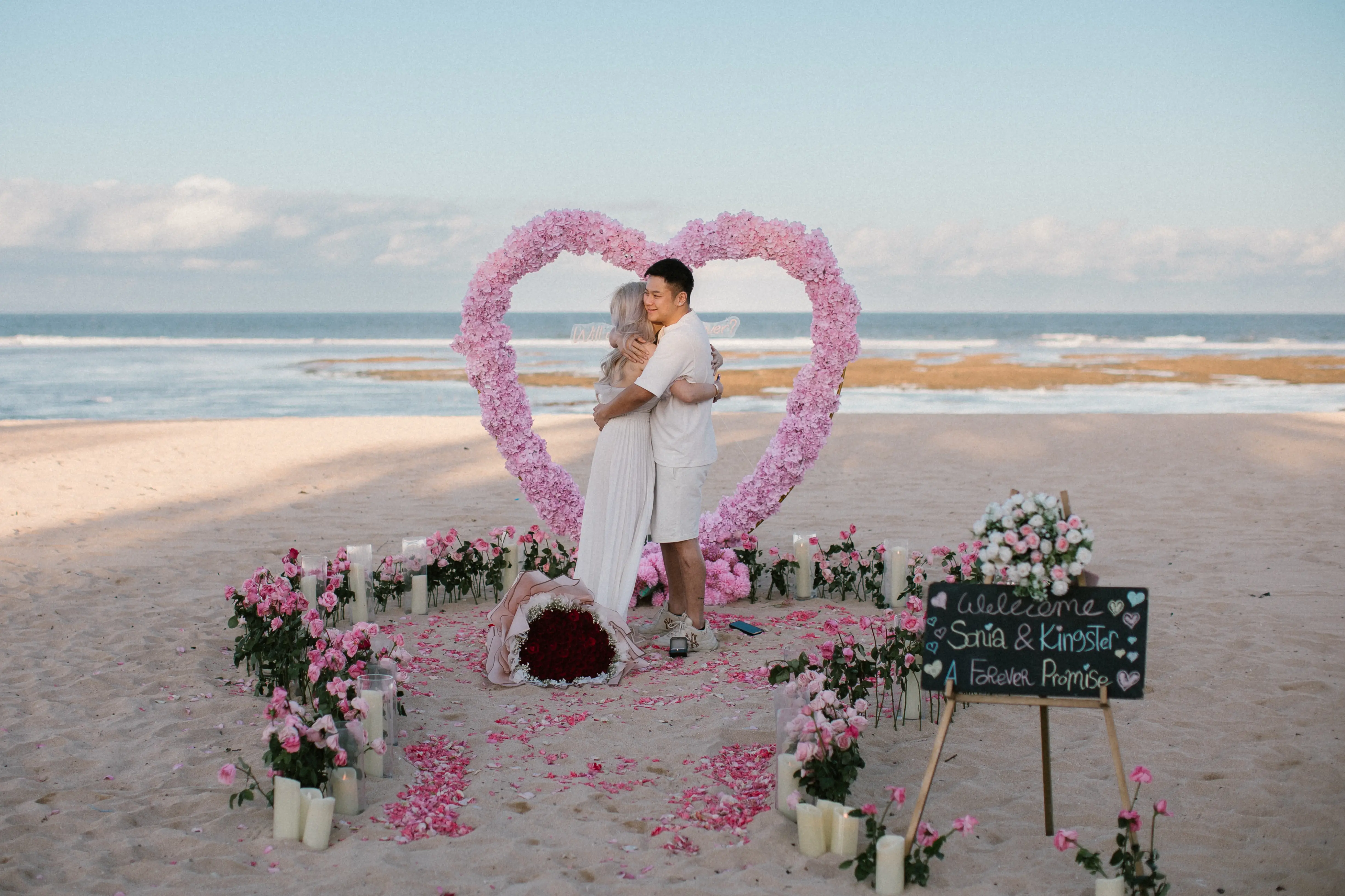 Romantic Bali marriage proposal with heart-shaped floral arch