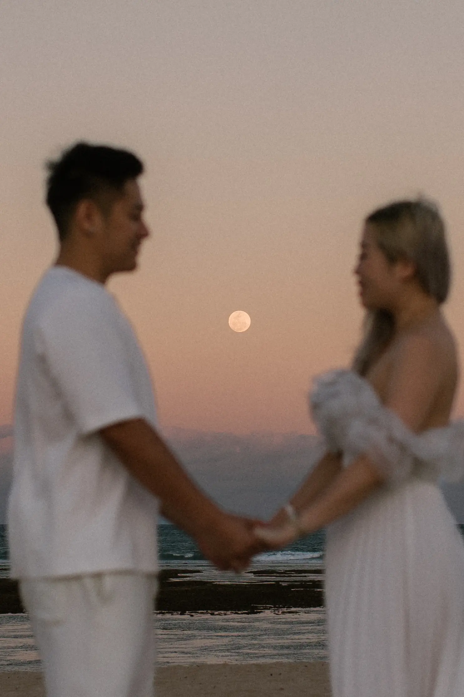 Couple engagement proposal in Bali at sunset by the ocean