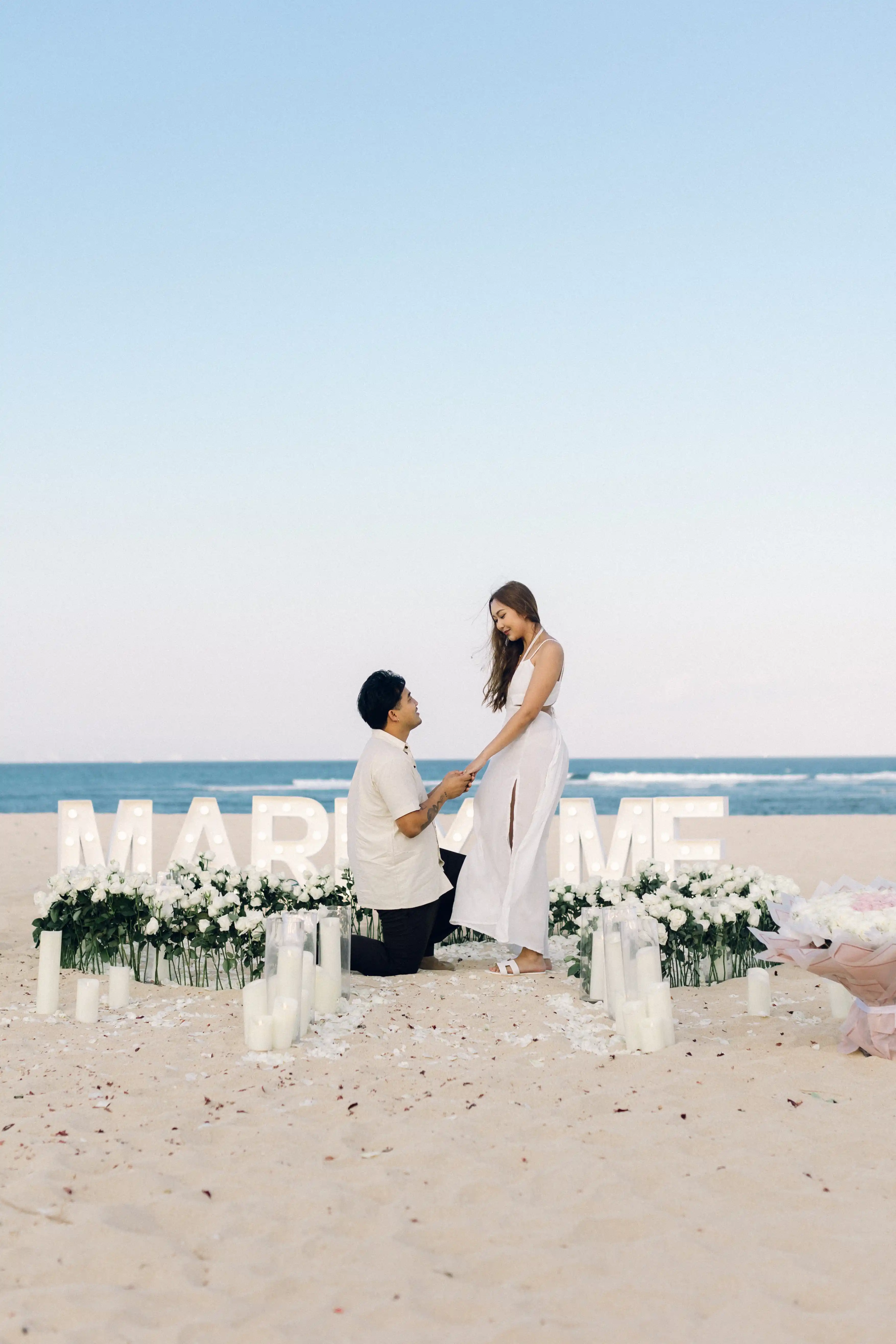Couple engagement moment on Bali beach