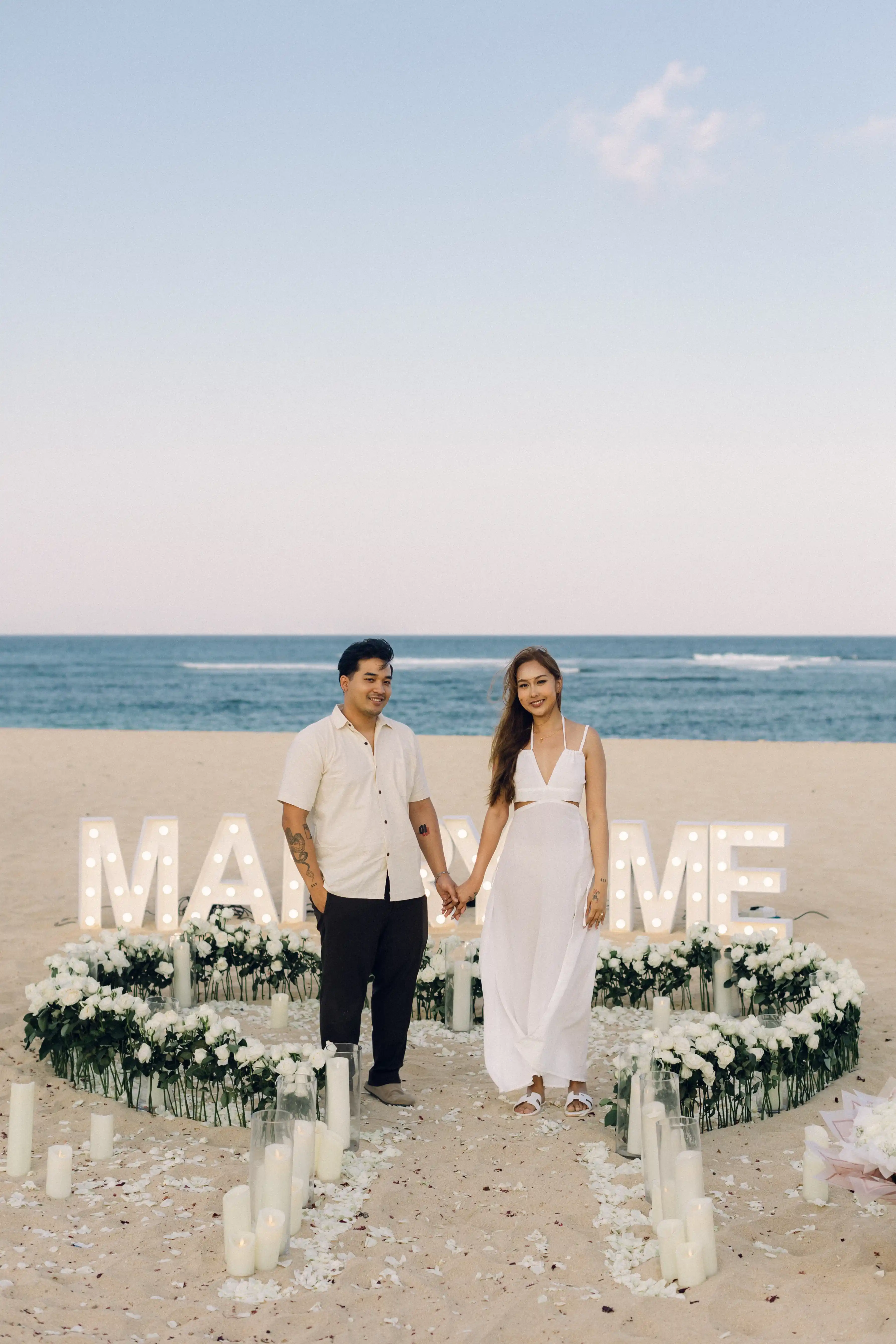 Beach proposal setup in Bali with flowers