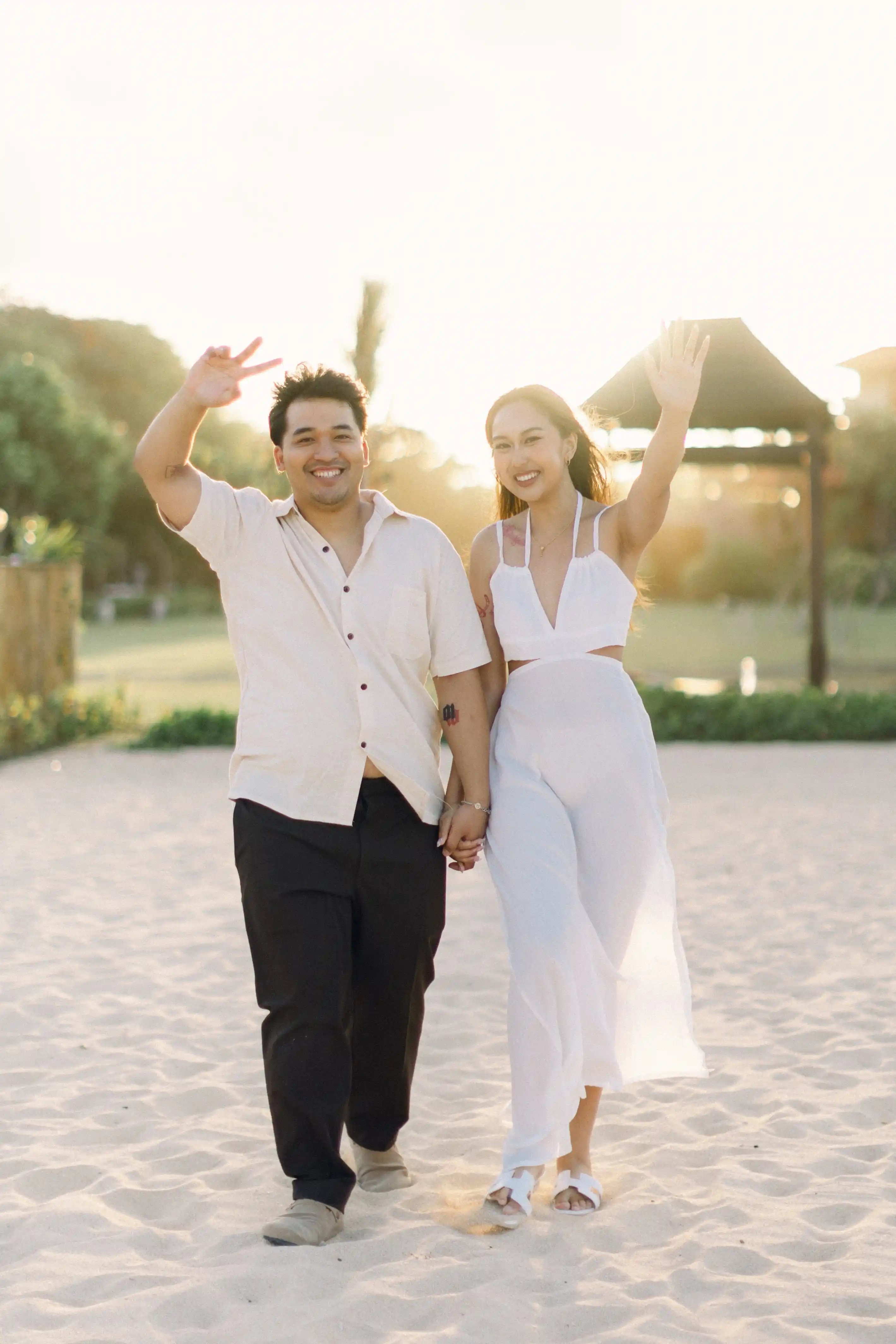 Sunset engagement on Bali beach with flowers