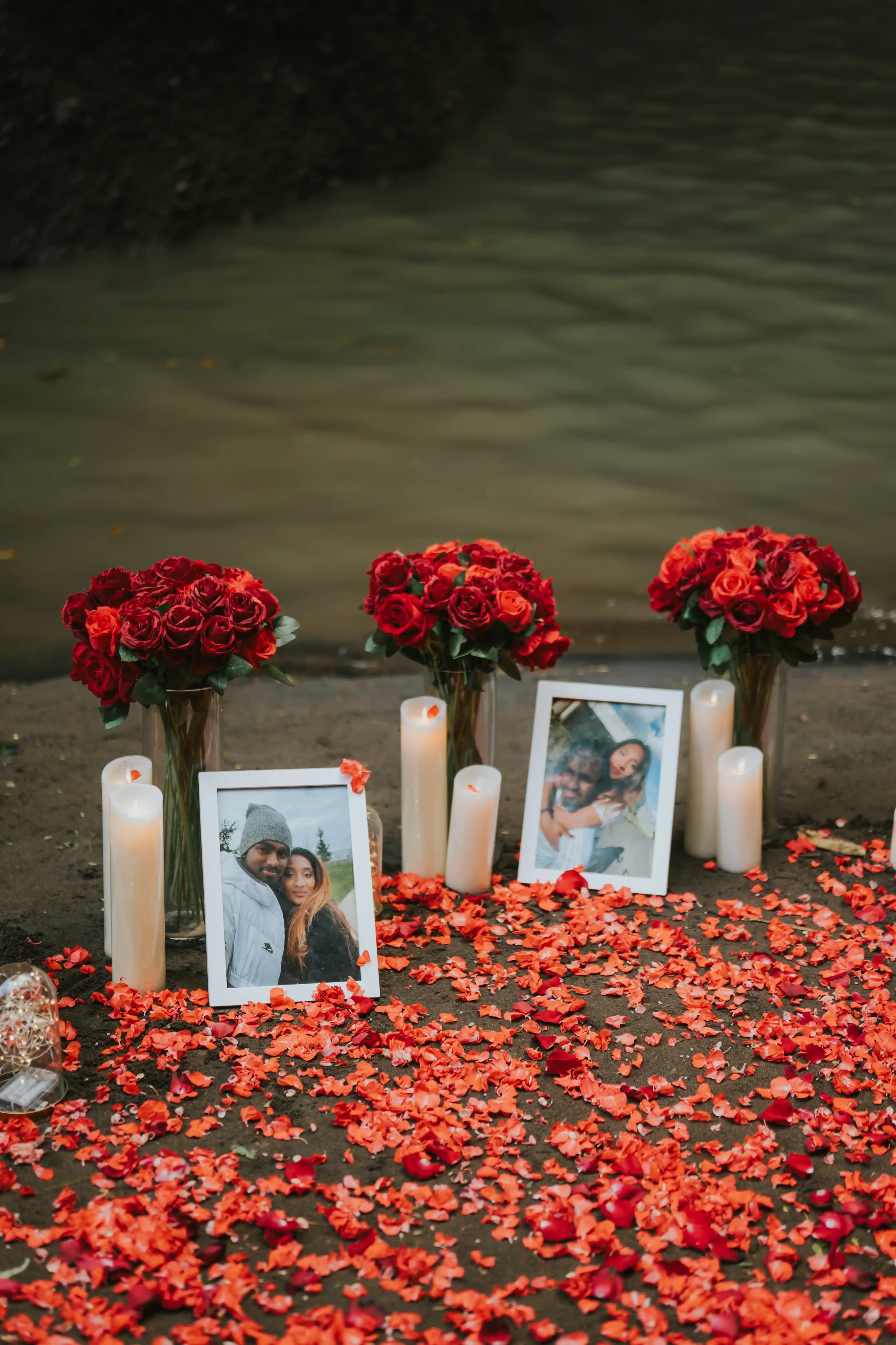 Romantic waterfall marriage proposal in Bali with red heart arch and rose petals