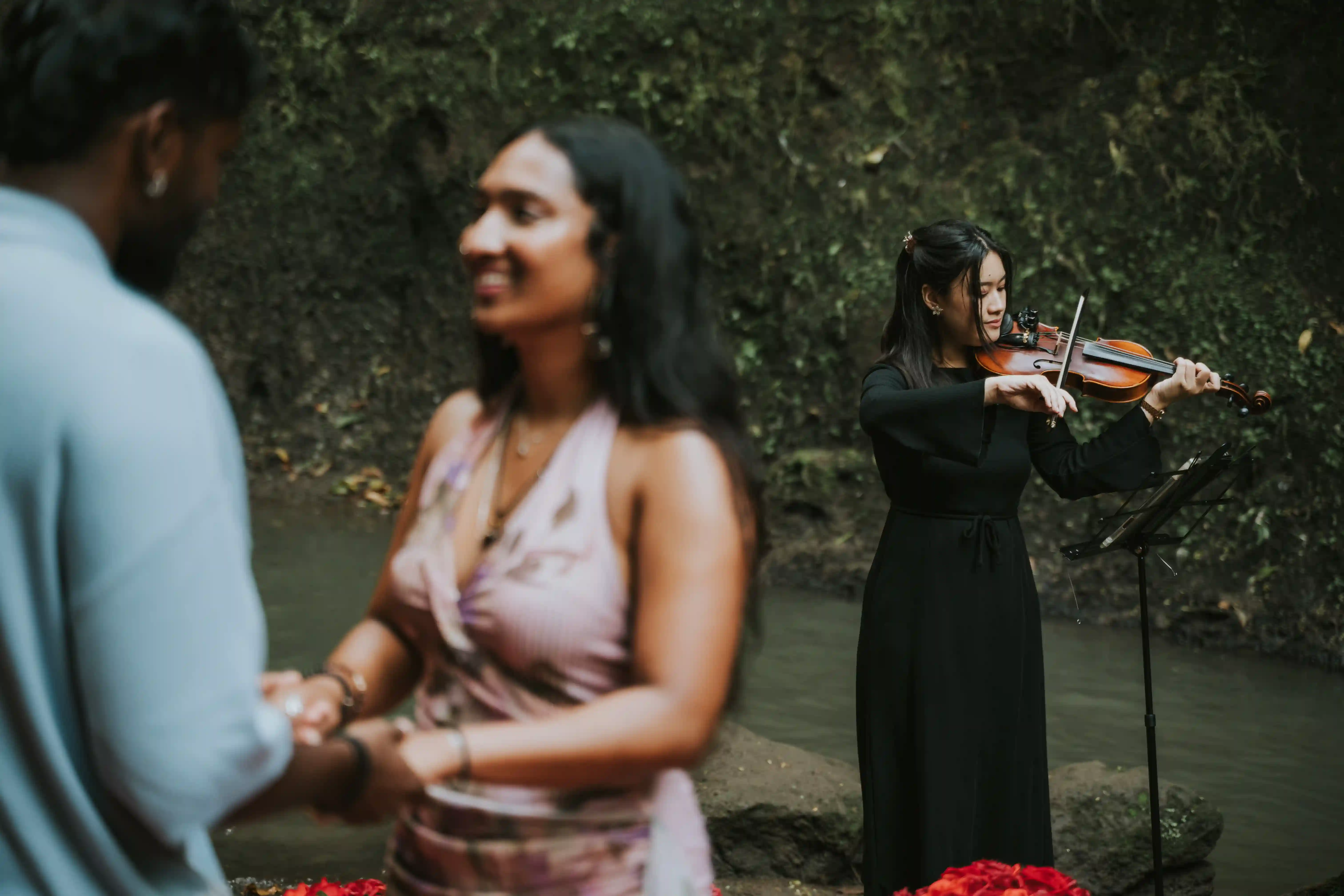 Couple during waterfall marriage proposal in Bali