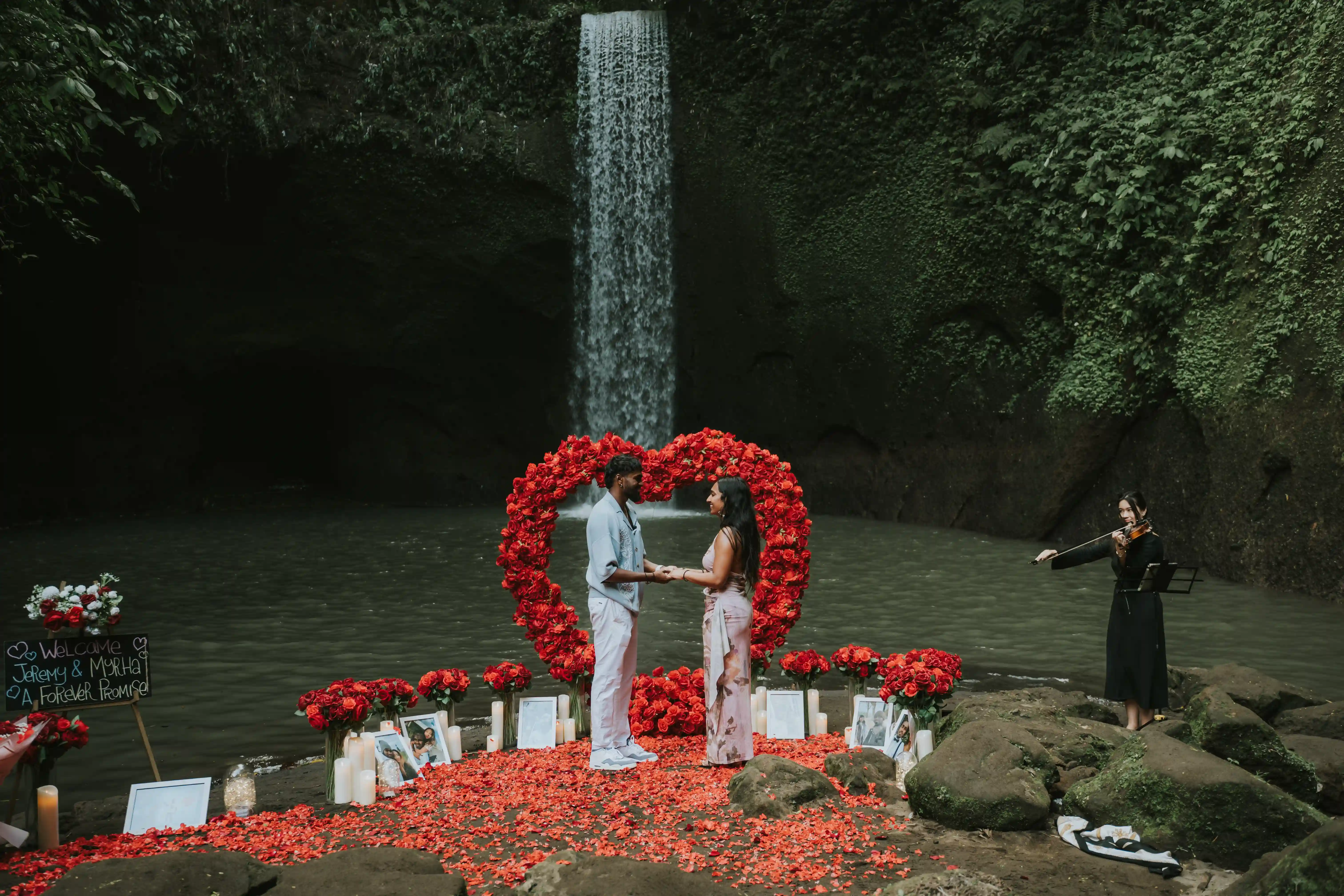 Engagement at Bali waterfall with heart arch and candle decorations