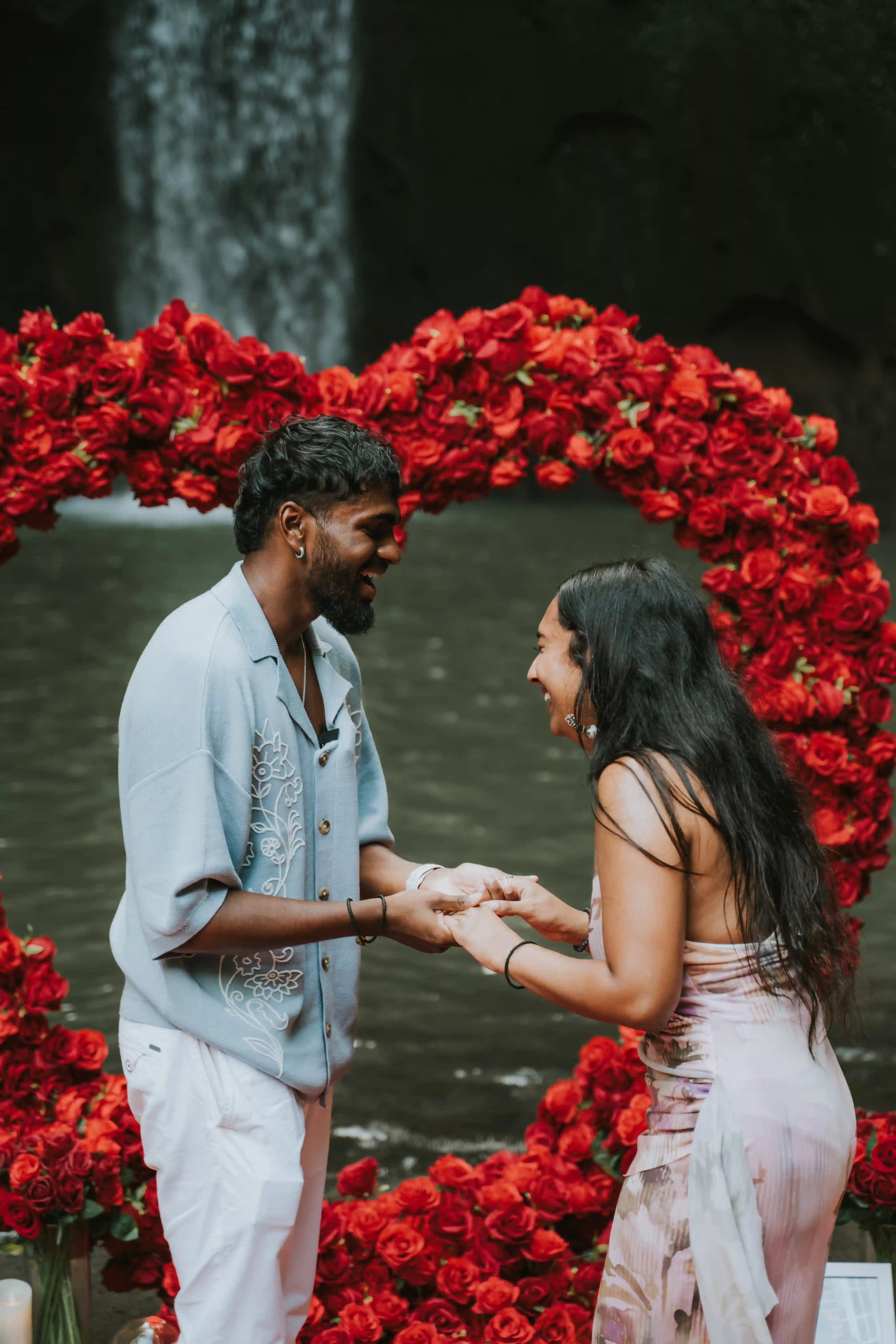 Couple celebrating engagement at waterfall in Bali