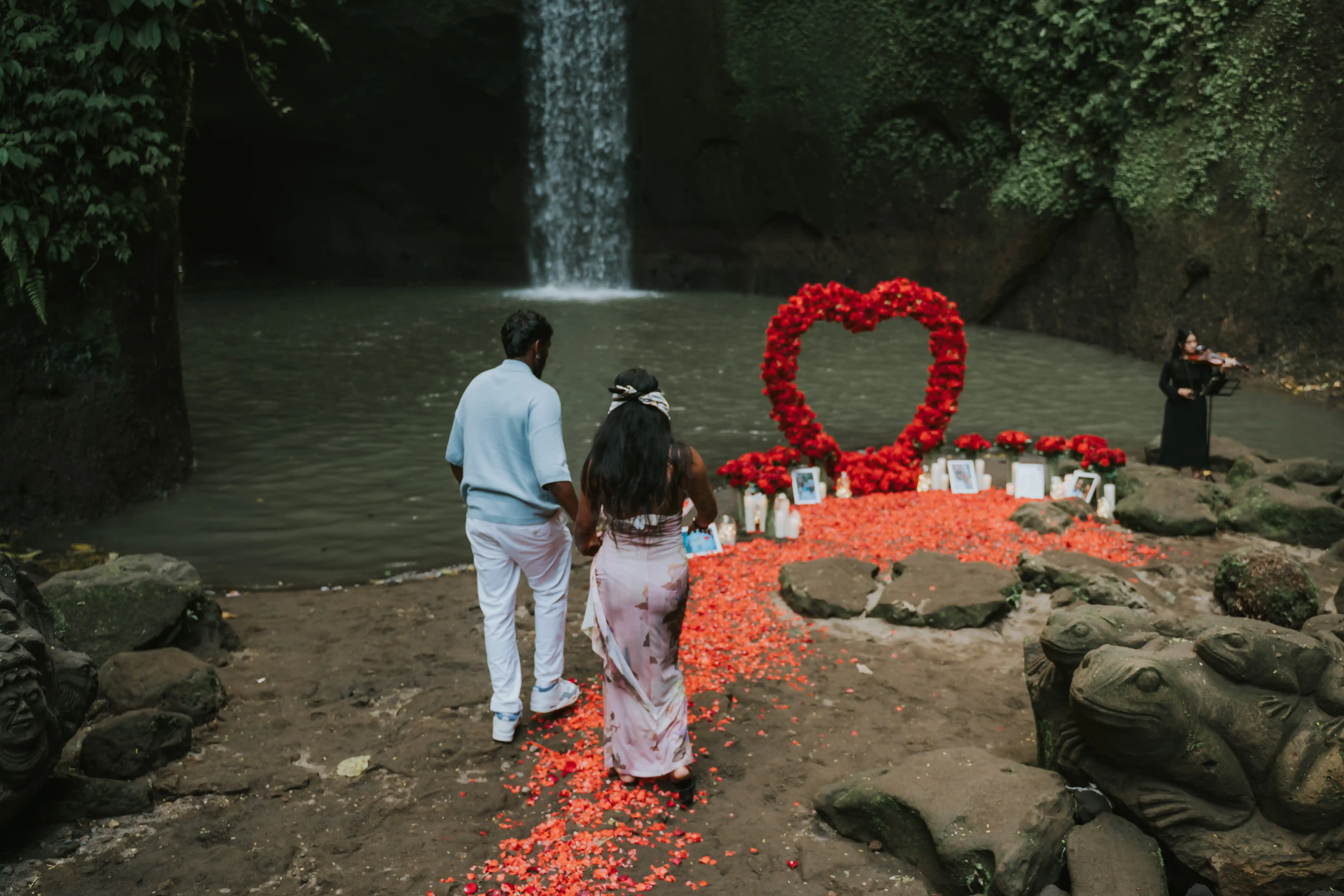 Waterfall proposal in Tibumana Bali with red flower arch