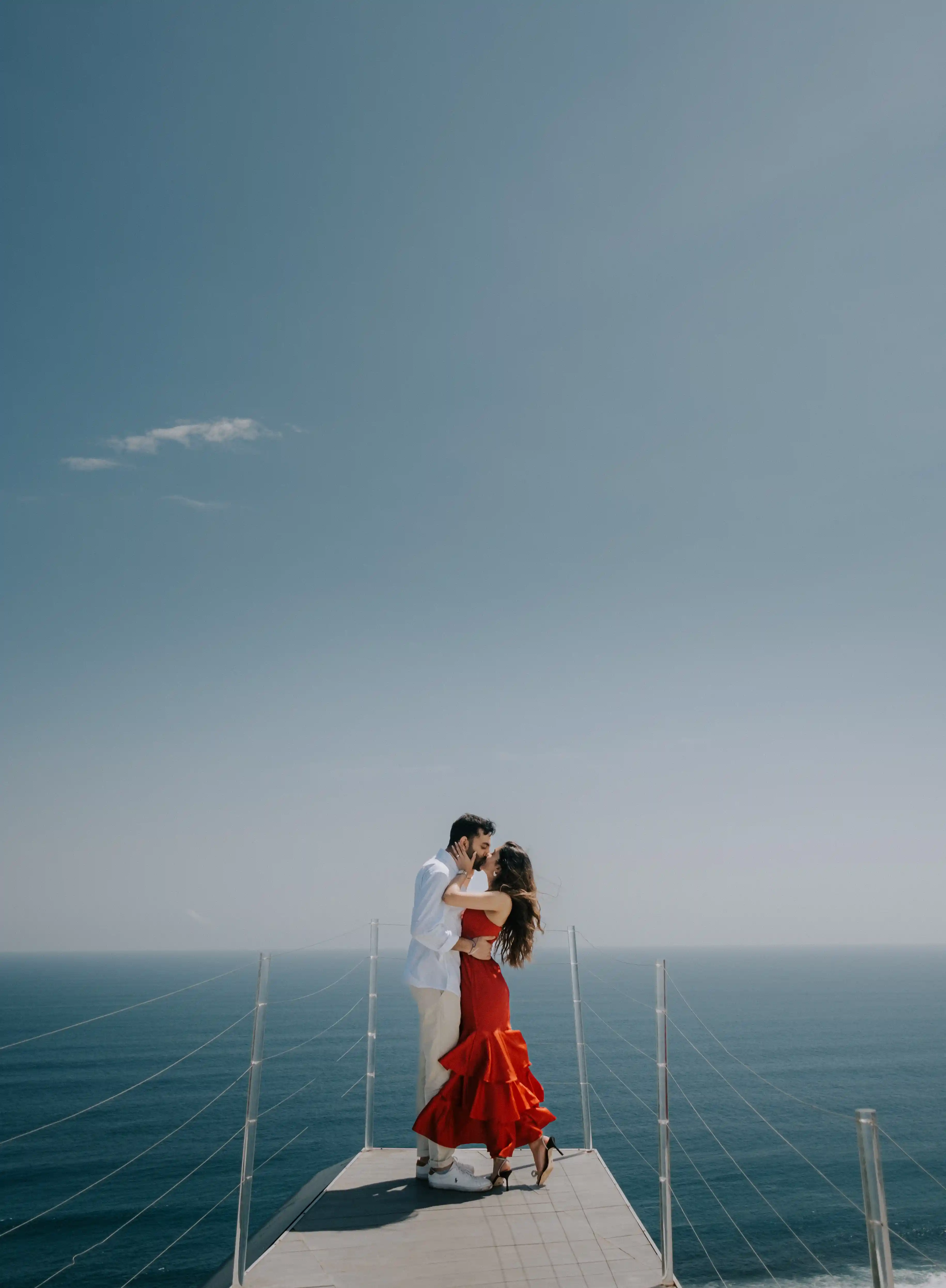 Romantic engagement moment in Bali with airplane villa backdrop.