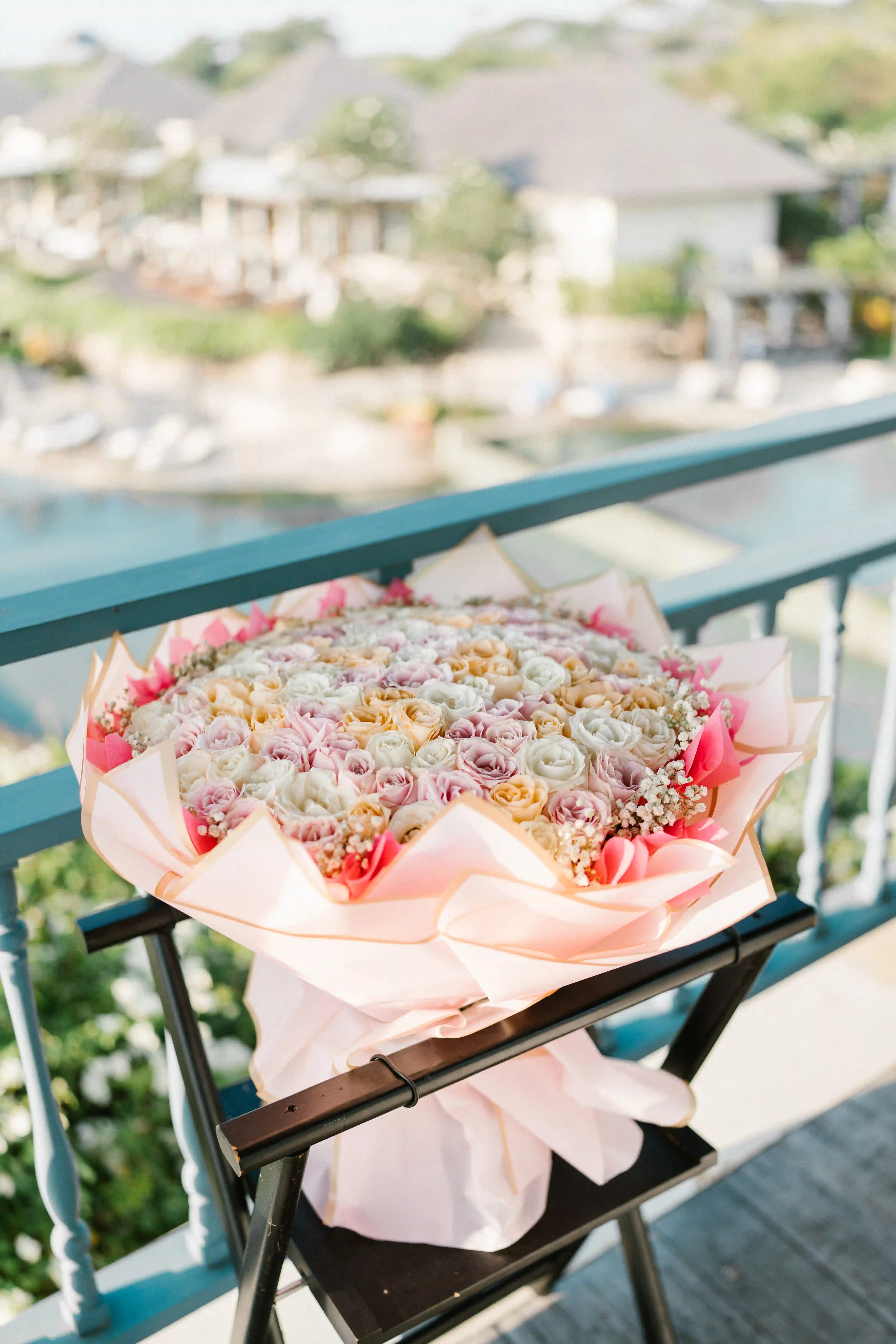 Romantic engagement in Bali with proposal ring and bouquet of flowers.