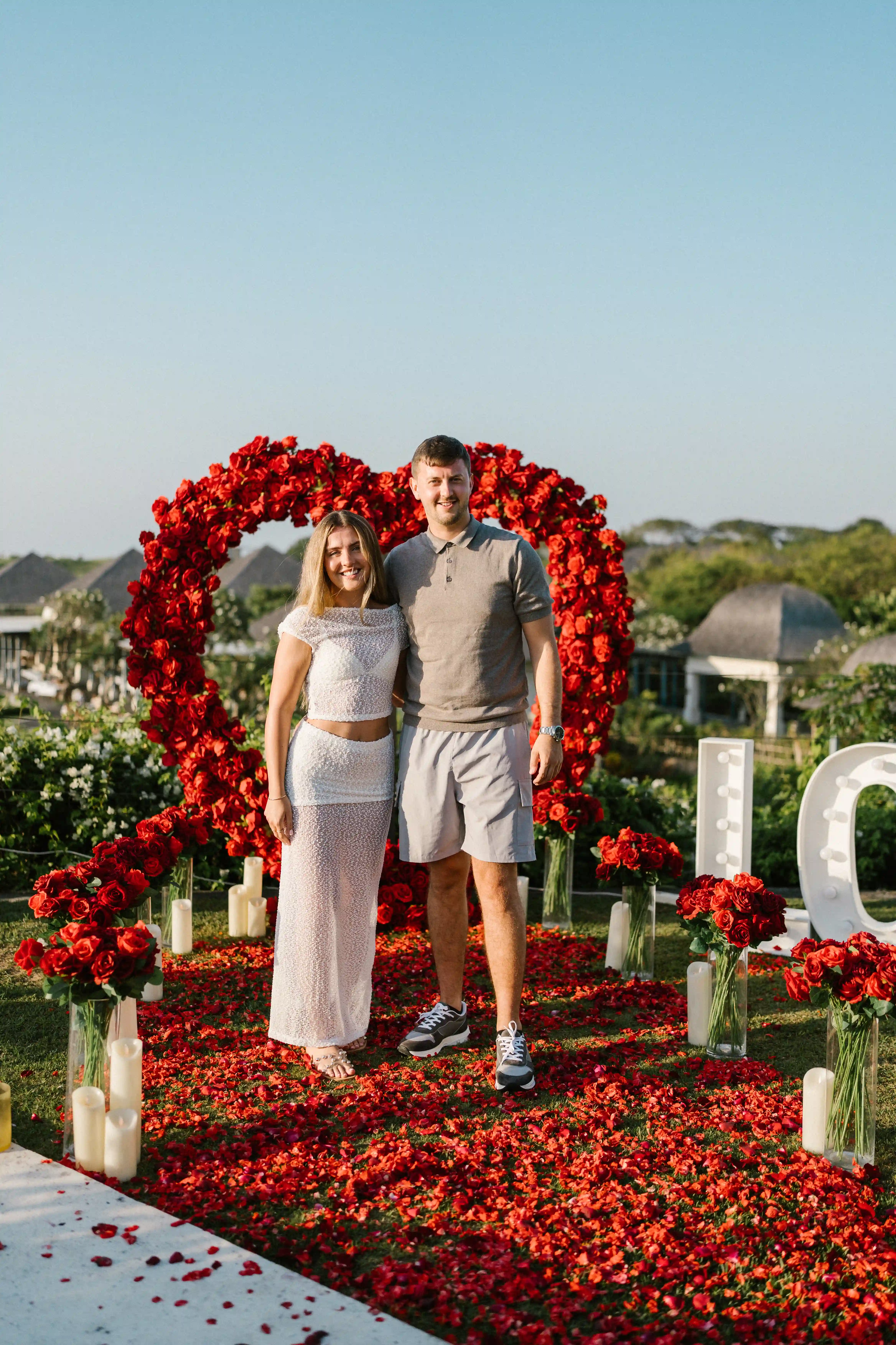 Marriage proposal setup in Bali with heart-shaped rose arch.