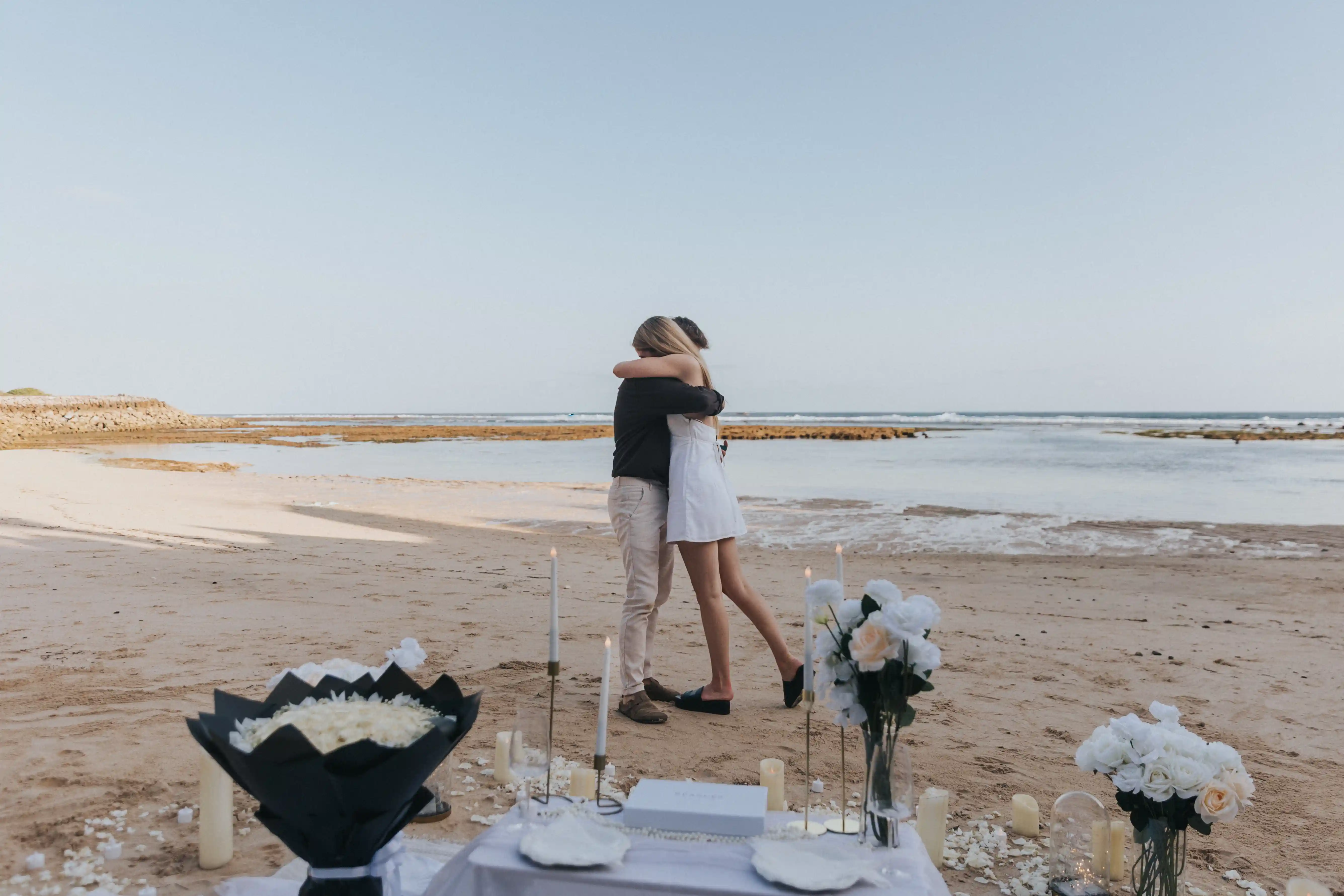 Couple happy after Bali engagement at the beach. 