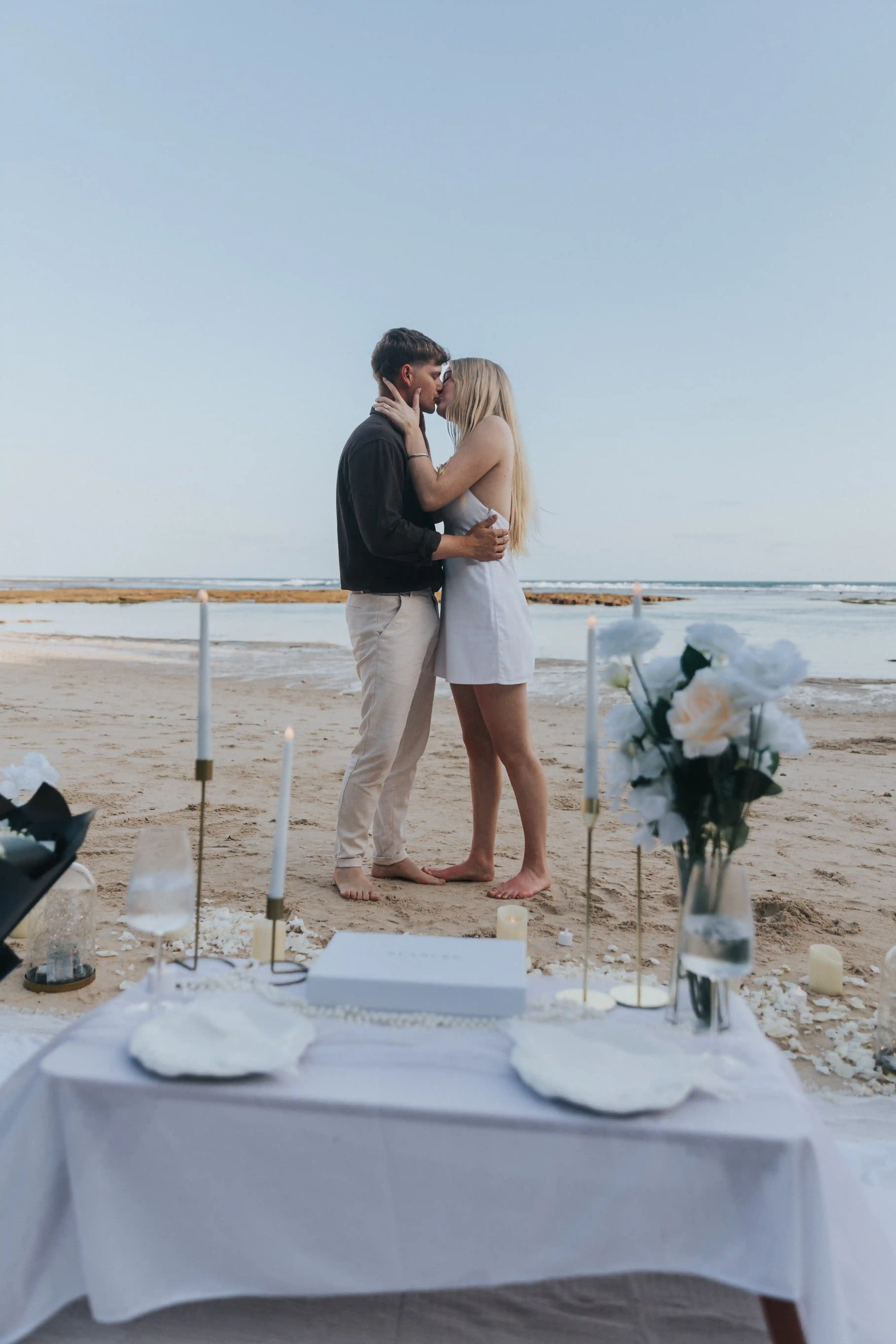 Just engaged couple sharing a kiss on the beach in Bali.