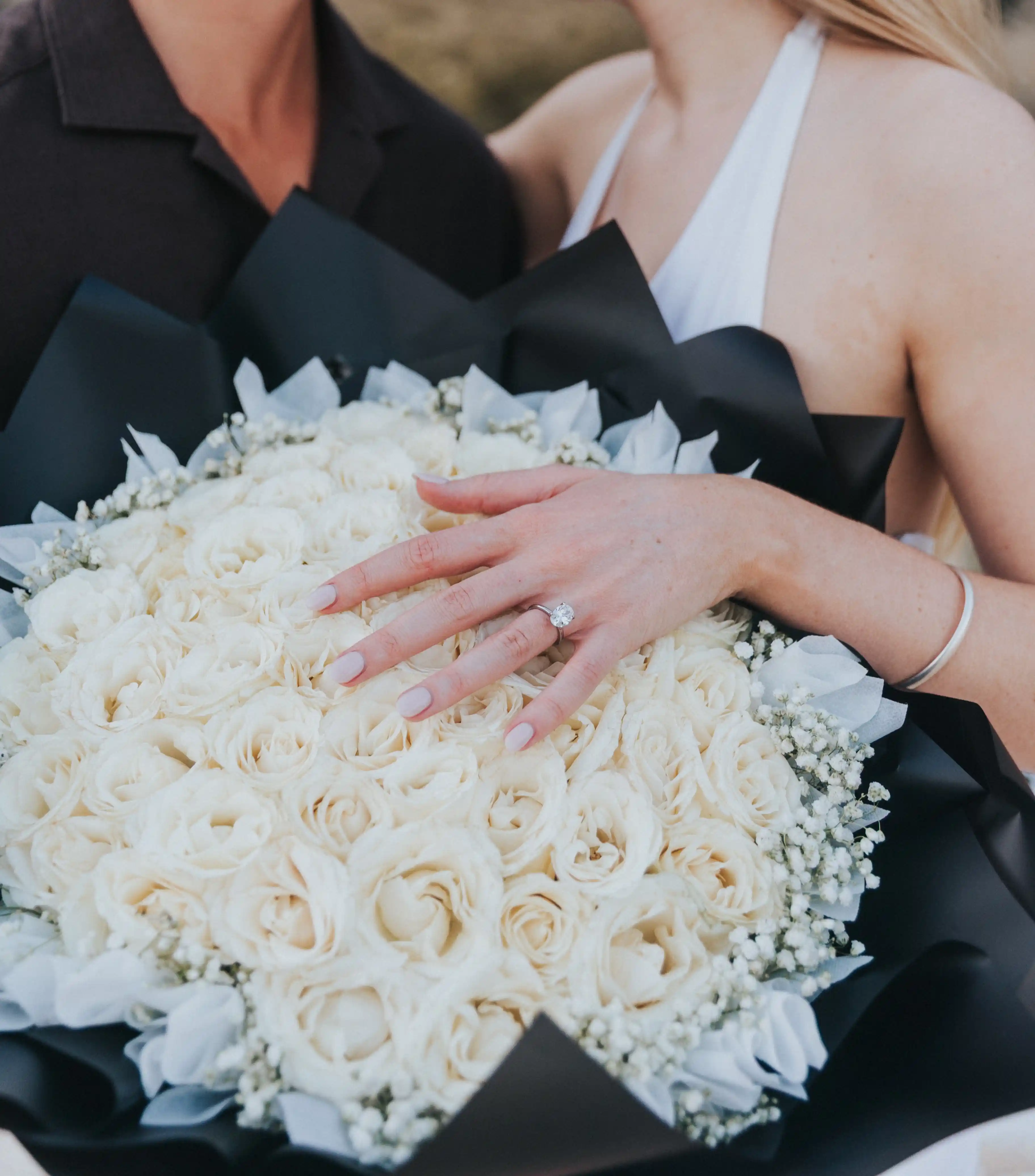 Close-up of engagement ring during Bali beach proposal.