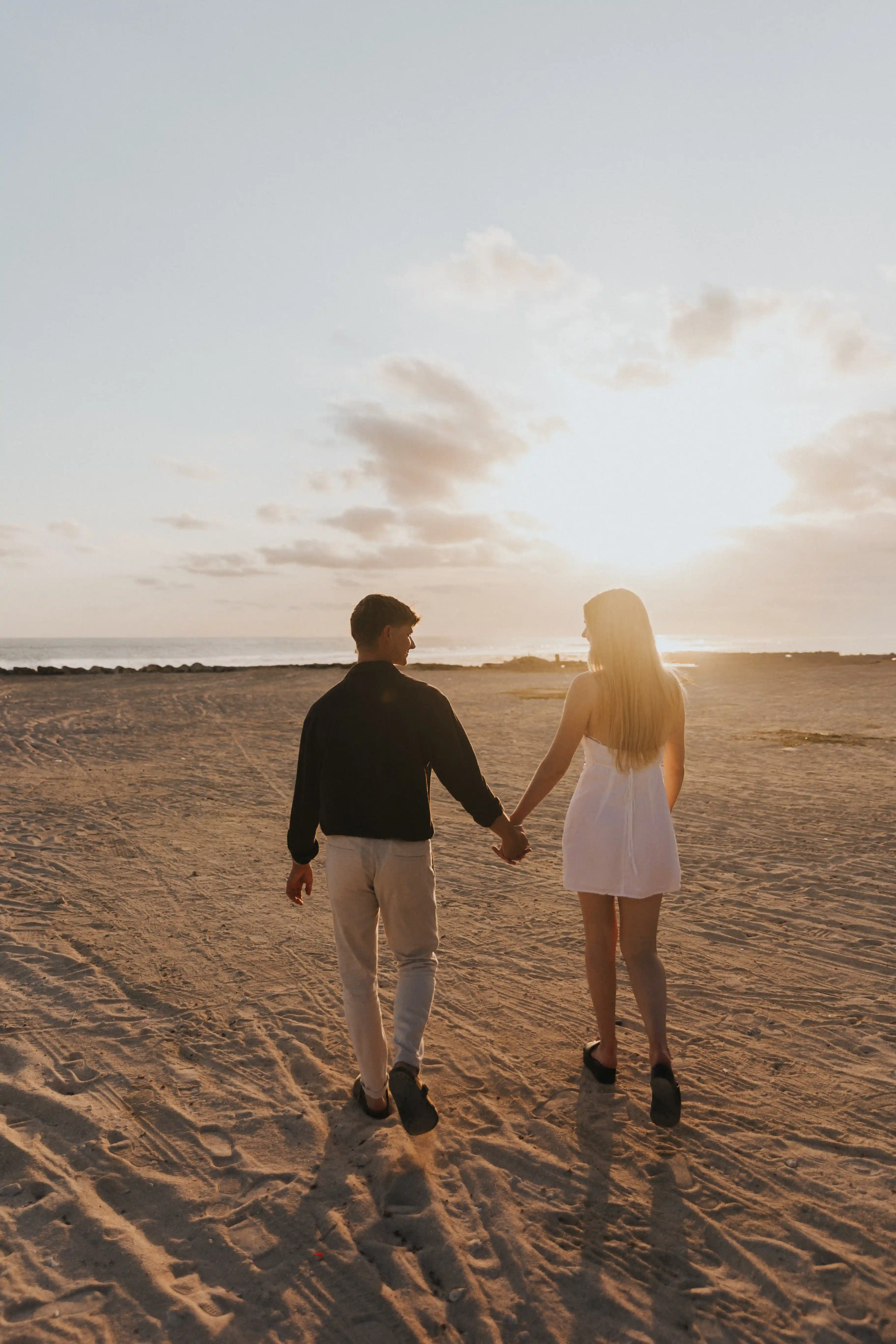 Couple walking hand in hand after marriage proposal. 
