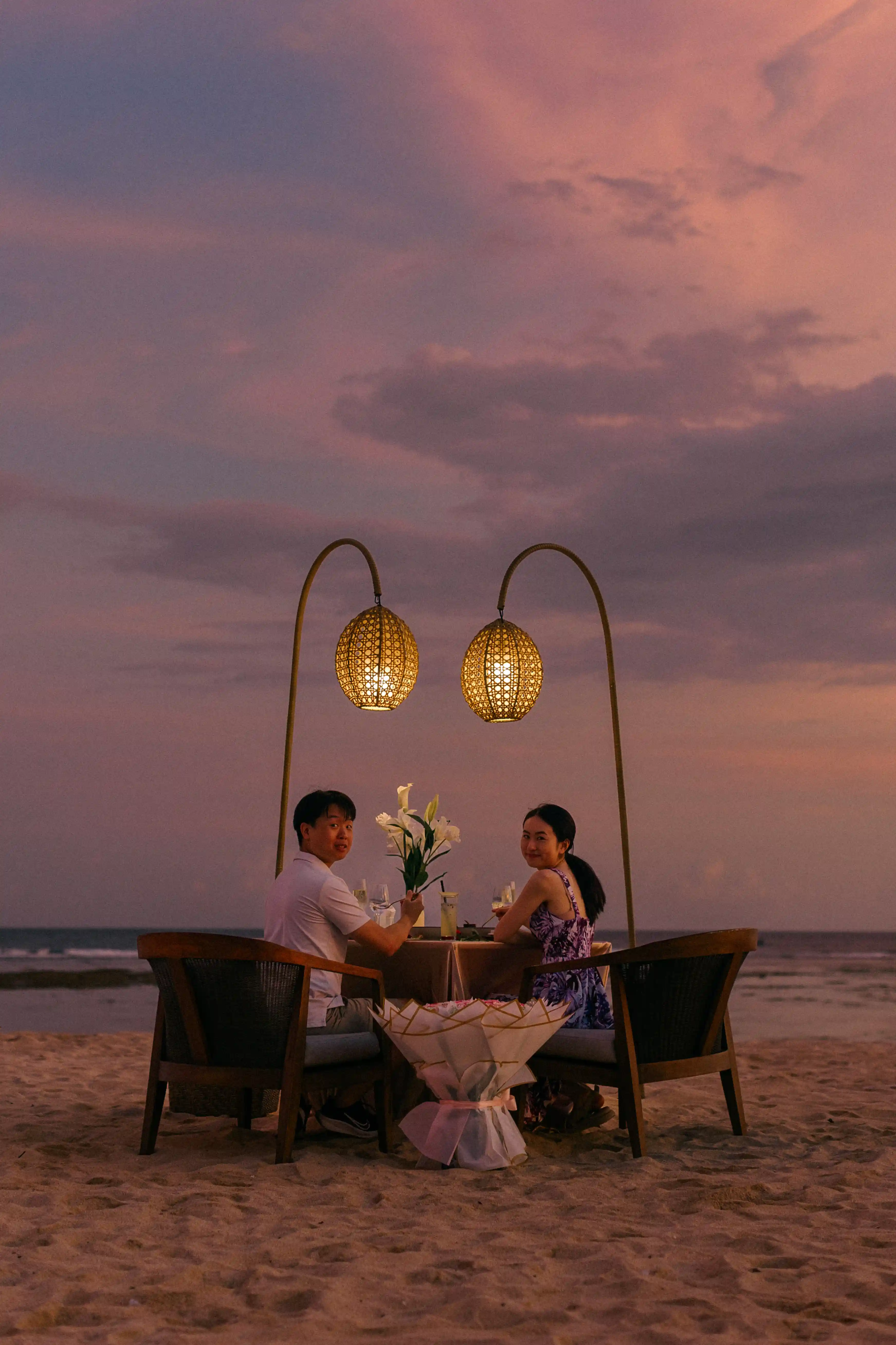 Private beach dinner setup for a romantic Bali engagement by the sea.