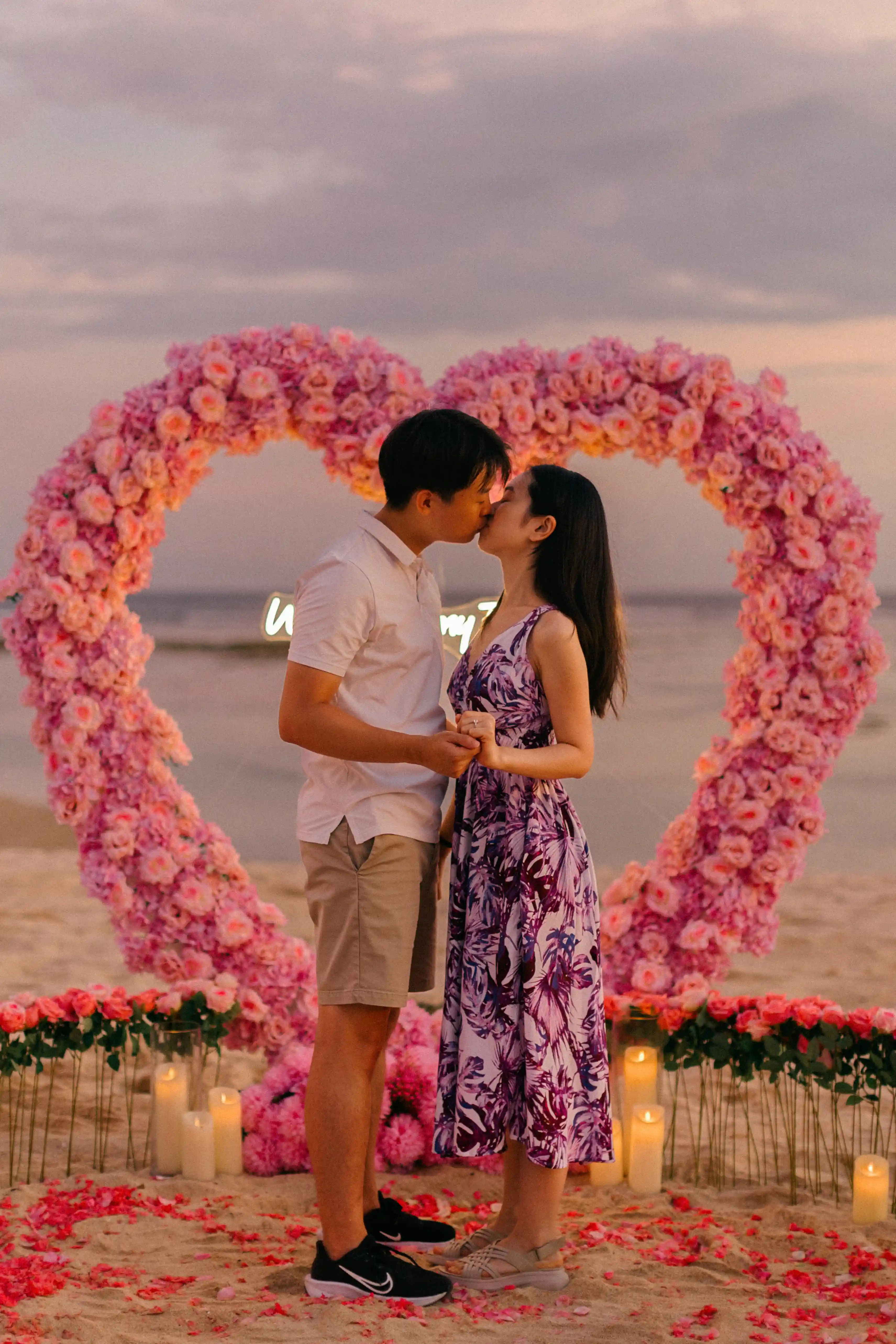 Heart arch proposal setup on the sand at sunset in Bali.
