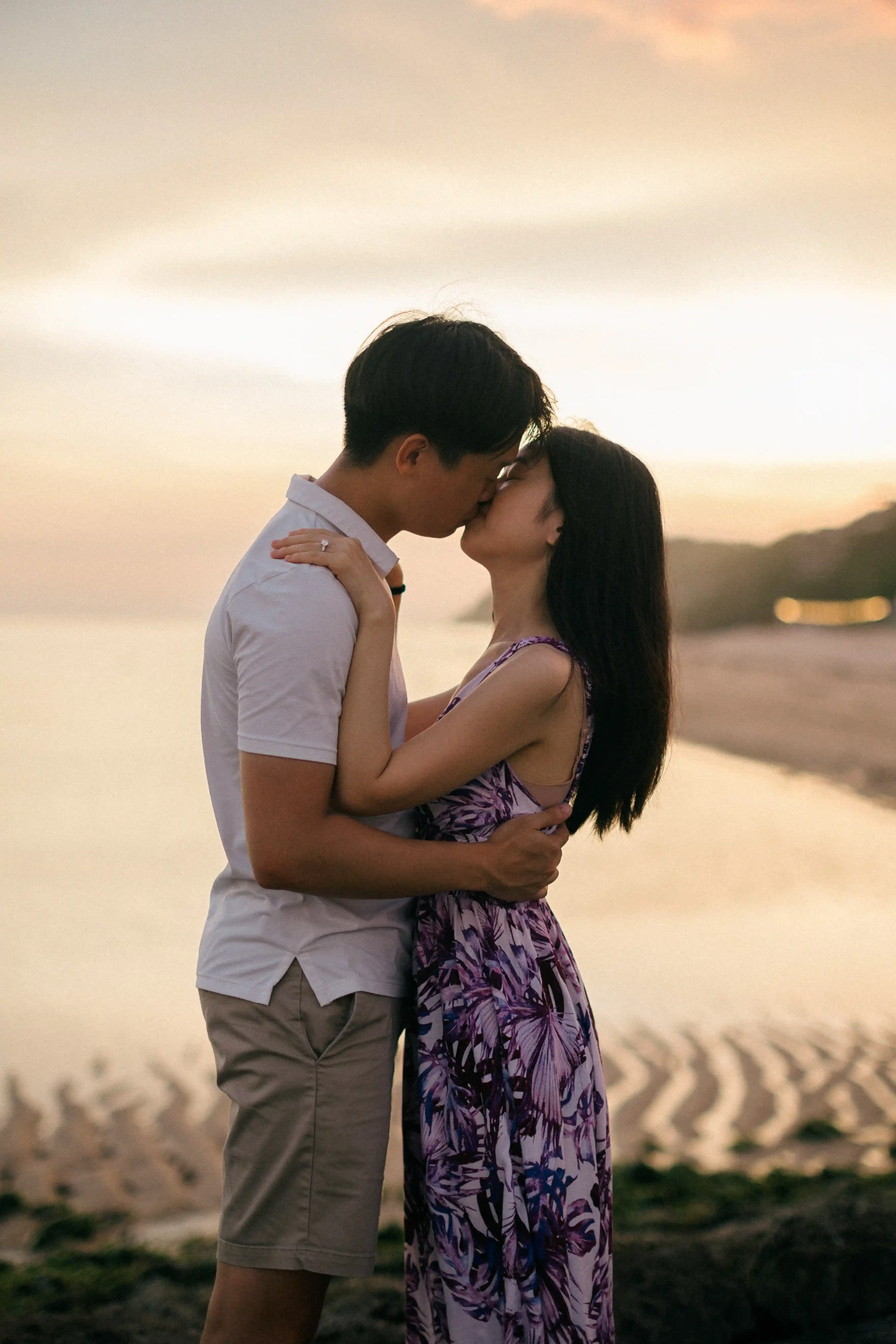 Couple sharing a kiss during their Bali beach engagement.