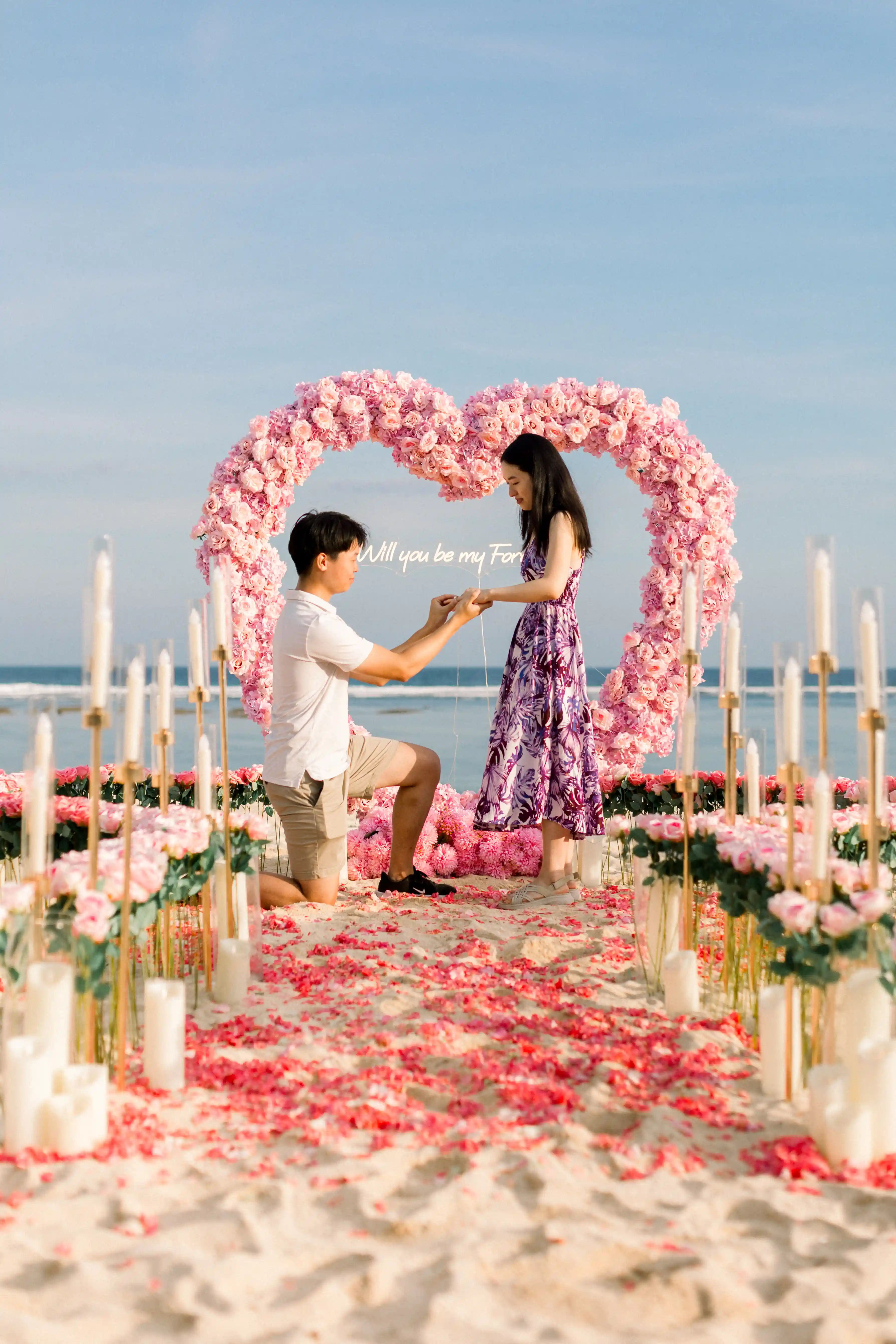 Man proposing to his partner on the beach in Bali.